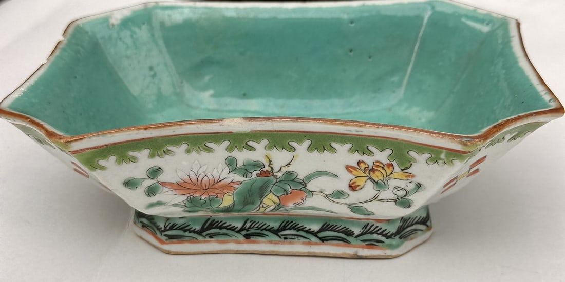 Chinese Famille Verte Porcelain Bowl Late Qing A hexagonal porcelain bowl delicately hand-painted in: A hexagonal porcelain bowl delicately hand-painted in the Famille Verte (Wucai) palette, featuring lotus blossoms, scrolling foliage, and auspicious motifs on a white ground, framed with a green and i