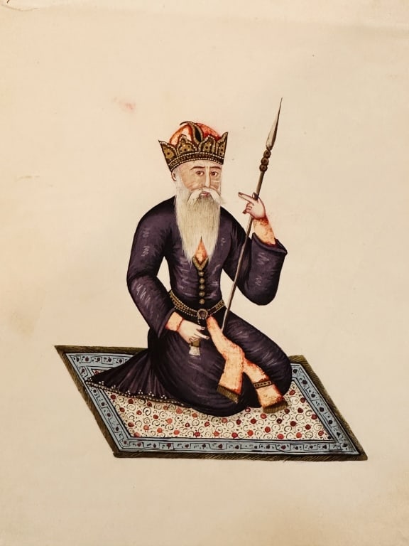Qajar miniature comprising a drawing of a mullah, The figure depicted is an elderly nobleman or: The figure depicted is an elderly nobleman or mollah , seated cross-legged on a finely detailed Persian carpet, holding a spear in one hand and a dagger (khanjar) at his waist.He wears a deep purple r