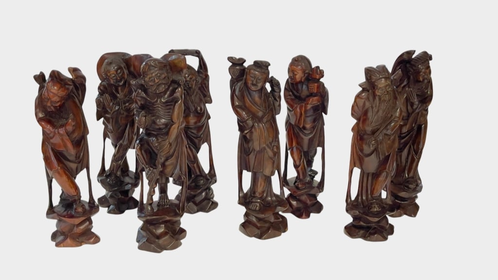 GROUP OF EIGHT CHINESE CARVED WOOD IMMORTAL FIGURS A collection of eight Chinese carved and polished (1 of 11)