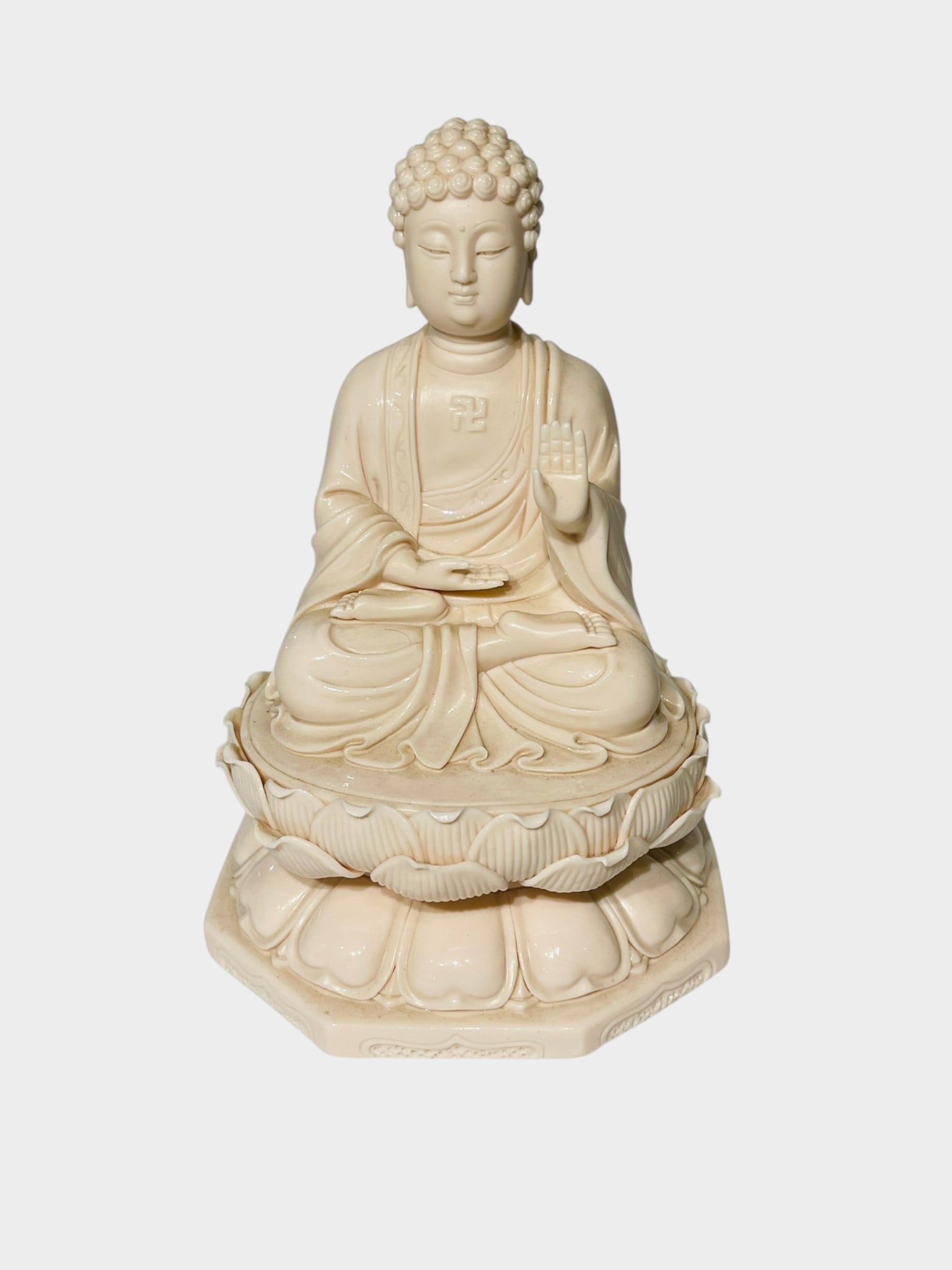 CHINESE DEHUA BLANC-DE-CHINE PORCELAIN FIGURE OF A A Chinese Dehua-style blanc-de-chine porcelain: A Chinese Dehua-style blanc-de-chine porcelain figure depicting the seated Buddha, modeled in meditation upon a double lotus pedestal. The figure with tightly curled hair, serene expression and flowin