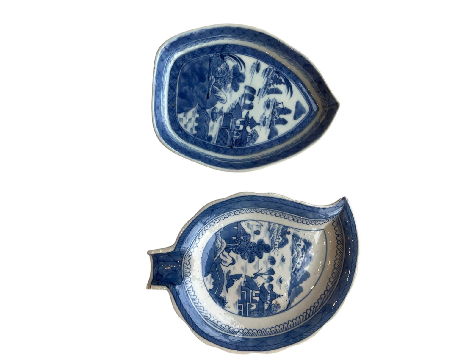 Pair of 19th-Century Blue and White Export Porcelain Leaf-Shaped Dishes / Sweetmeat Trays: A matching pair of antique 19th-century export porcelain dishes molded in organic leaf forms with short stem handles.Design & Motifs: Hand-painted in underglaze cobalt blue with intricate Chinoiserie 