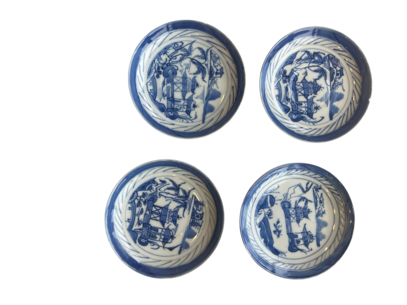 Set of Four 19th-Century Blue and White Export Porcelain Saucers with Willow Landscapes: A matching set of four antique nineteenth-century porcelain saucers or small cabinet dishes.Design & Motifs: Hand-painted in underglaze cobalt blue with classic Chinoiserie river landscapes featuring 