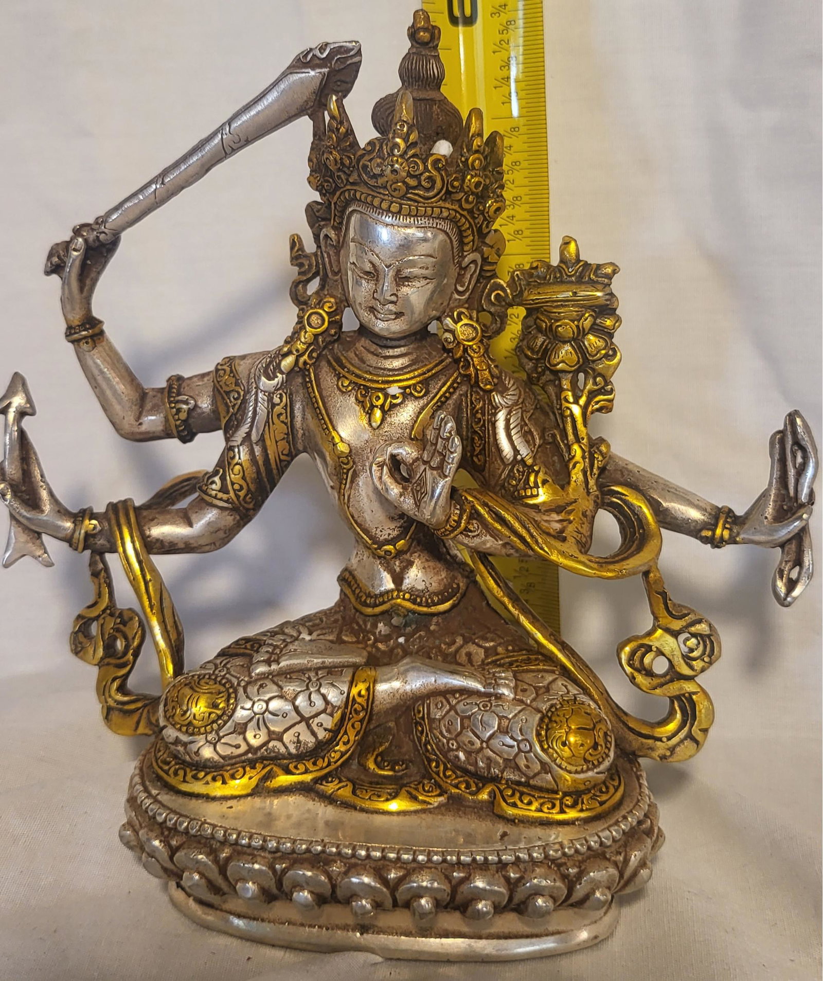 Manjushri Buddhist Statue: Silver and gold tones. Manjushri personifies supreme wisdom. His name in Sanskrit means â€œgentle, or sweet, glory”; he is also known as MÃ£njughoá¹£a (â€œSweet Voice”) and V�