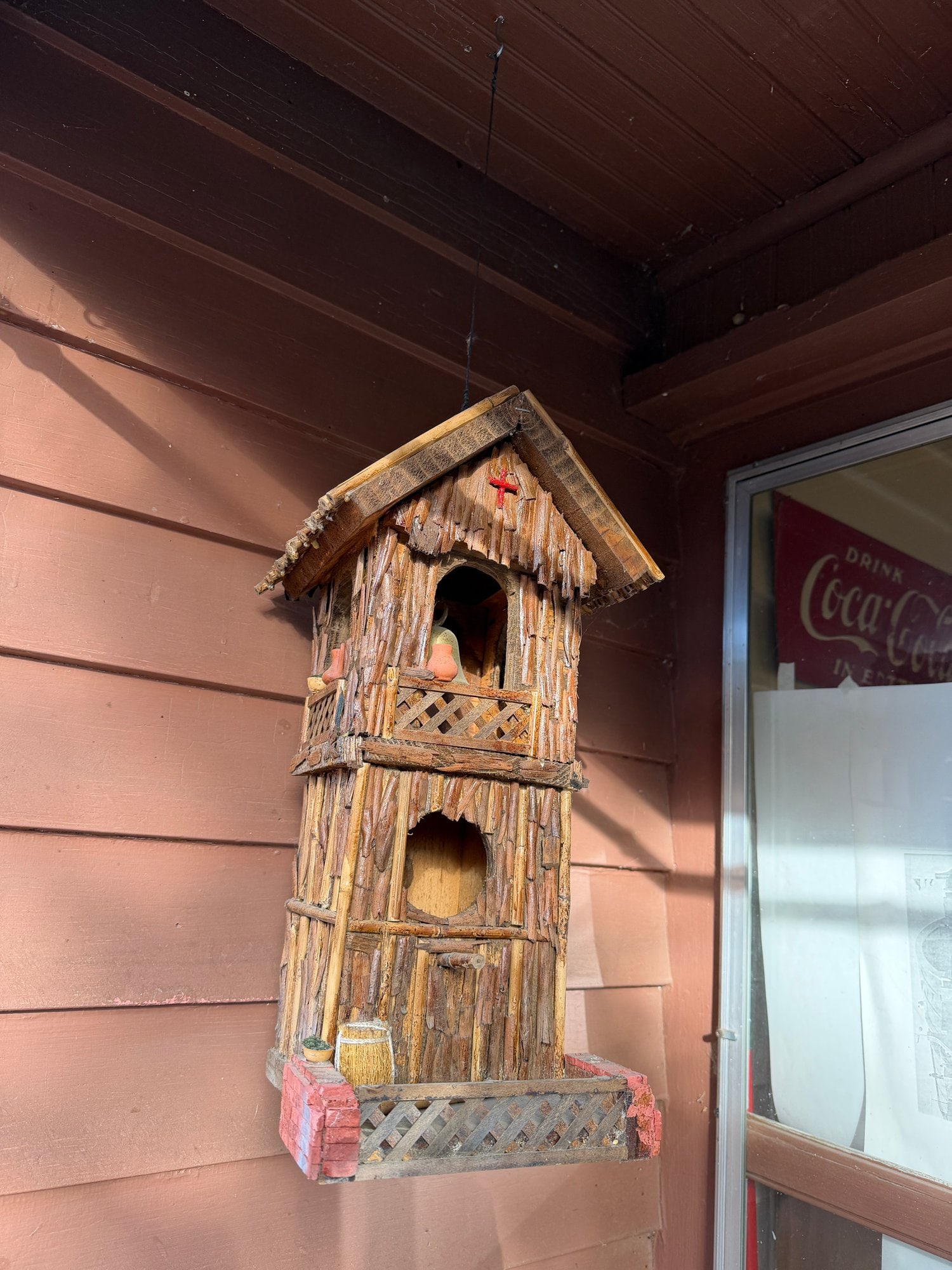 Rustic Thatched-Roof Birdhouse: A decorative, fully functional birdhouse constructed from wood with a natural, textured thatched roof. The design often includes whimsical details like a small chimney, a front perch, and a "distresse