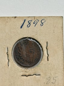 1898 Indian Head Cent housed in a protective 2x2 cardboard flip.