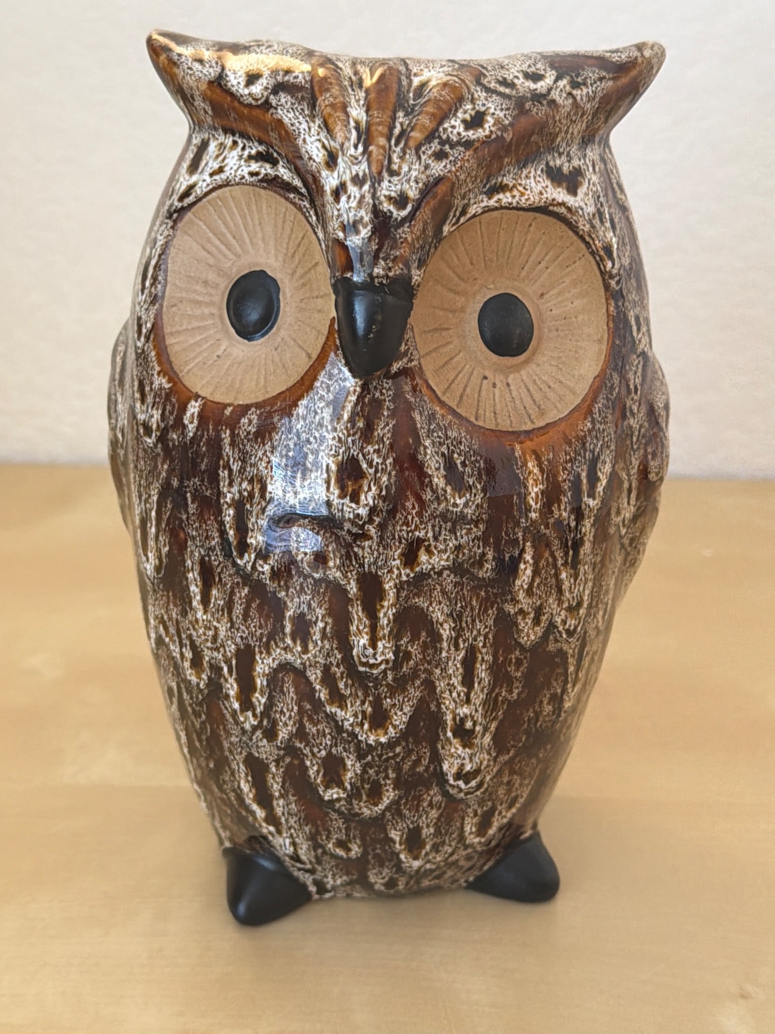 8-Inch Ceramic Owl Figurine with Brown and Tan Glaze: Ceramic owl figurine standing 8 inches tall with a textured brown and tan glaze finish. Features wide, detailed eyes and a hand-crafted appearance. The underside shows natural ceramic material with bl