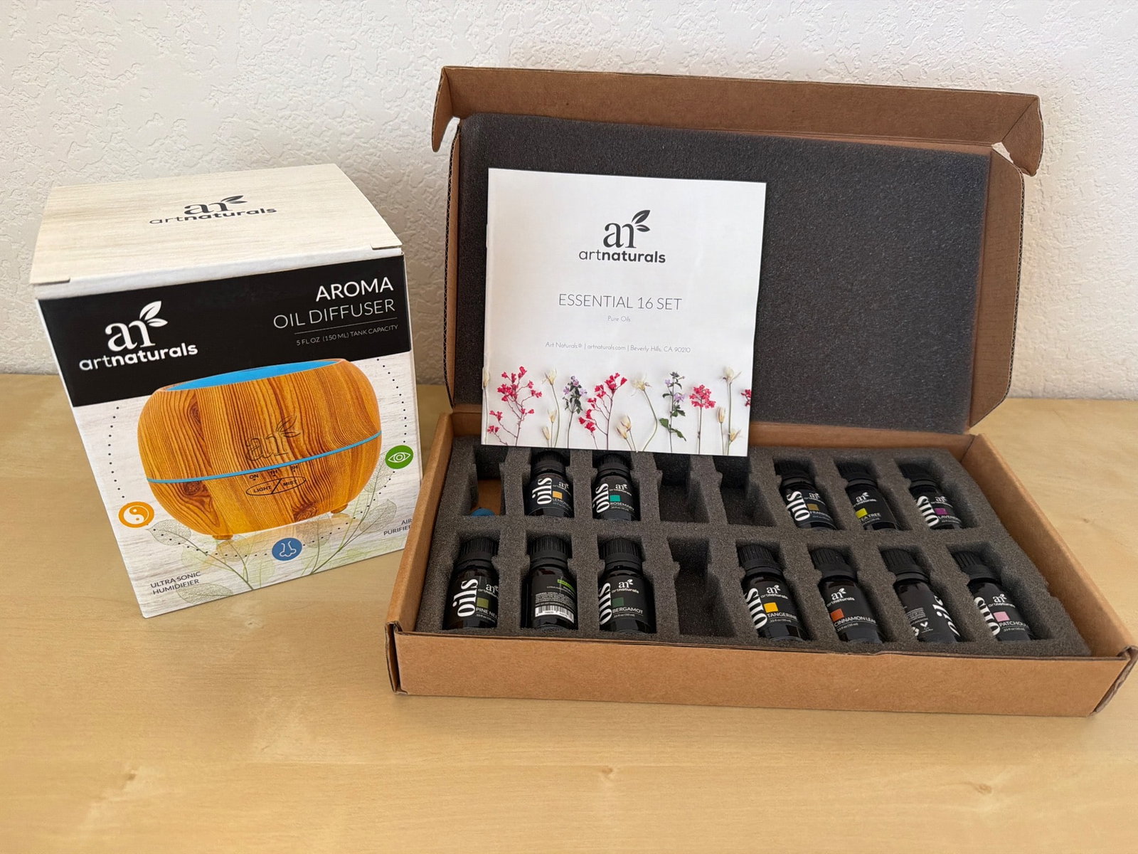 ArtNaturals Aromatherapy Essential Oil and Diffuser Set: ArtNaturals Aromatherapy set featuring a diffuser in its original packaging and a collection of essential oils. Includes 16 different essential oils stored in a sturdy box with foam inserts for secure