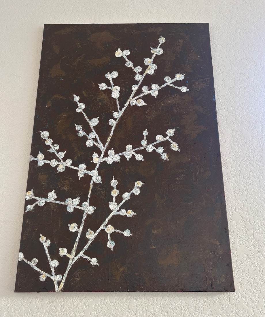 Floral Branch Painting on Canvas With Wooden Frame: A floral branch painting on a textured canvas featuring white blossoms on a dark brown background. Mounted on a wooden frame, this artwork is suitable for display in various settings. Dimensions provi