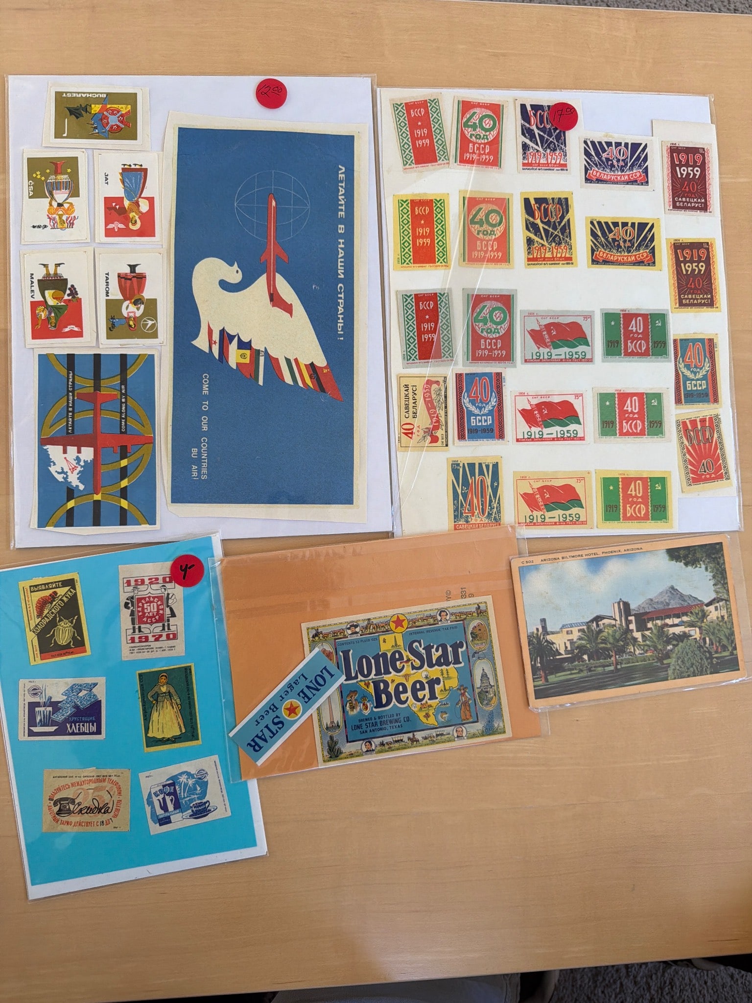 Vintage Matchbox Labels and Ephemera: Vintage matchbox labels and related ephemera. Includes various designs and types, such as propaganda-themed, advertising, and regional labels. Items are displayed on sheets and include additional item