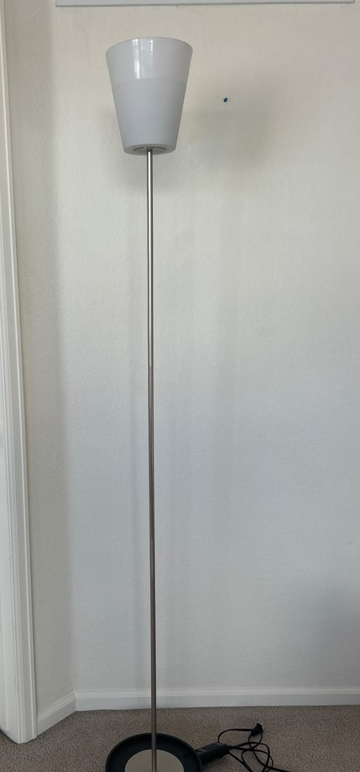 Modern Floor Lamp with Frosted White Shade and Metal Base: Modern floor lamp featuring a frosted white plastic shade, a sleek metal pole, and a weighted circular base for stability. Includes an inline footswitch for convenient operation. Compatible bulb and w