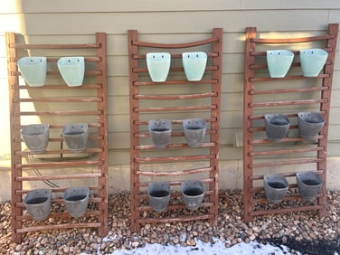 Three Wooden Plant Racks With Plastic Pots