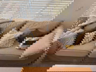 Beige Two-Seater Sofa with Decorative Cushions – Well Loved / Worn