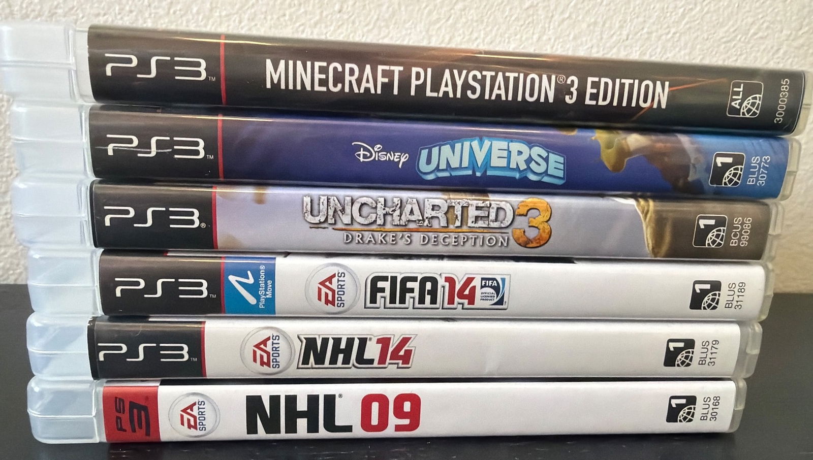 6 Complete PlayStation 3 Video Games: Six PlayStation 3 video games featuring titles such as Minecraft PlayStation 3 Edition, Disney Universe, Uncharted 3: Drake's Deception, FIFA 14, NHL 14, and NHL 09. All games come in their respective