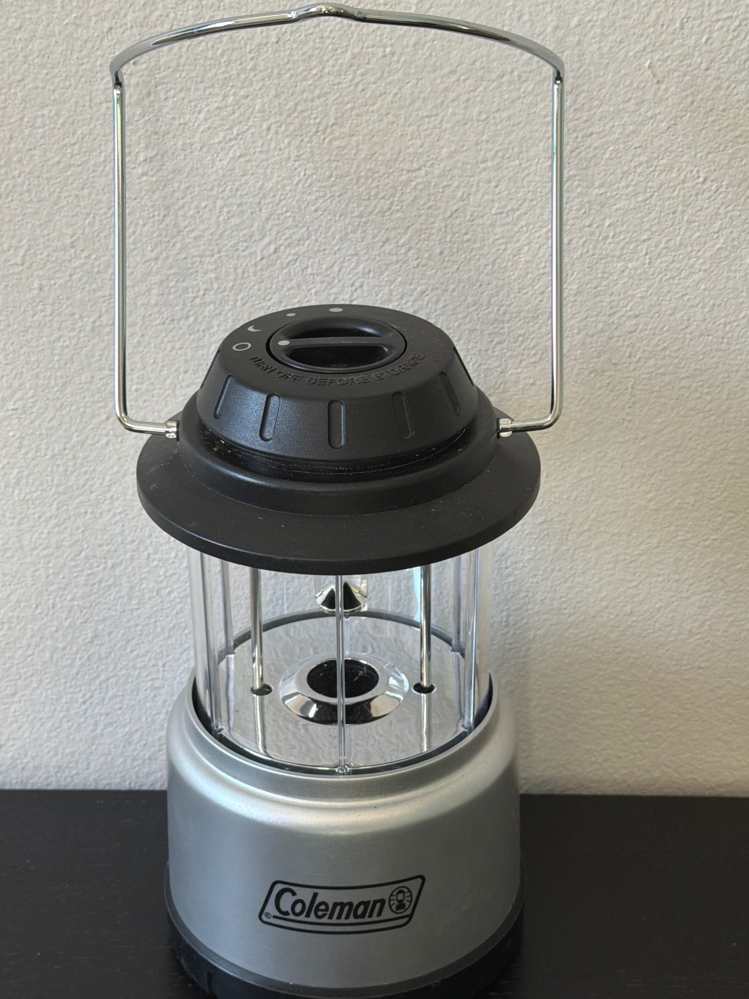 Coleman Battery-Powered Lantern with Plastic and Metal Construction: Coleman battery-powered lantern featuring a plastic and metal construction with a classic camping lantern design. Includes a sturdy handle for hanging or carrying. Ideal for outdoor or emergency light