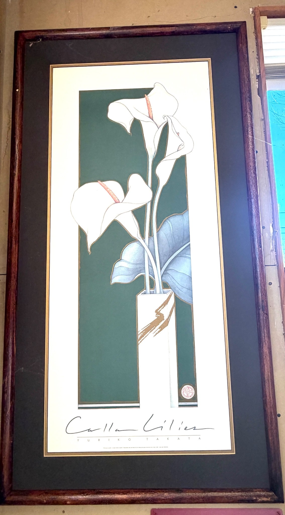Yuriko Takata Calla Lilies Framed Print: Framed print titled 'Calla Lilies' by artist Yuriko Takata. This piece features a floral illustration of white calla lilies in a vase against a green background. The artwork is signed by the artist in