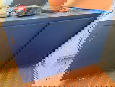 Blue Wooden Two-Door Cabinet with Flat Top Surface