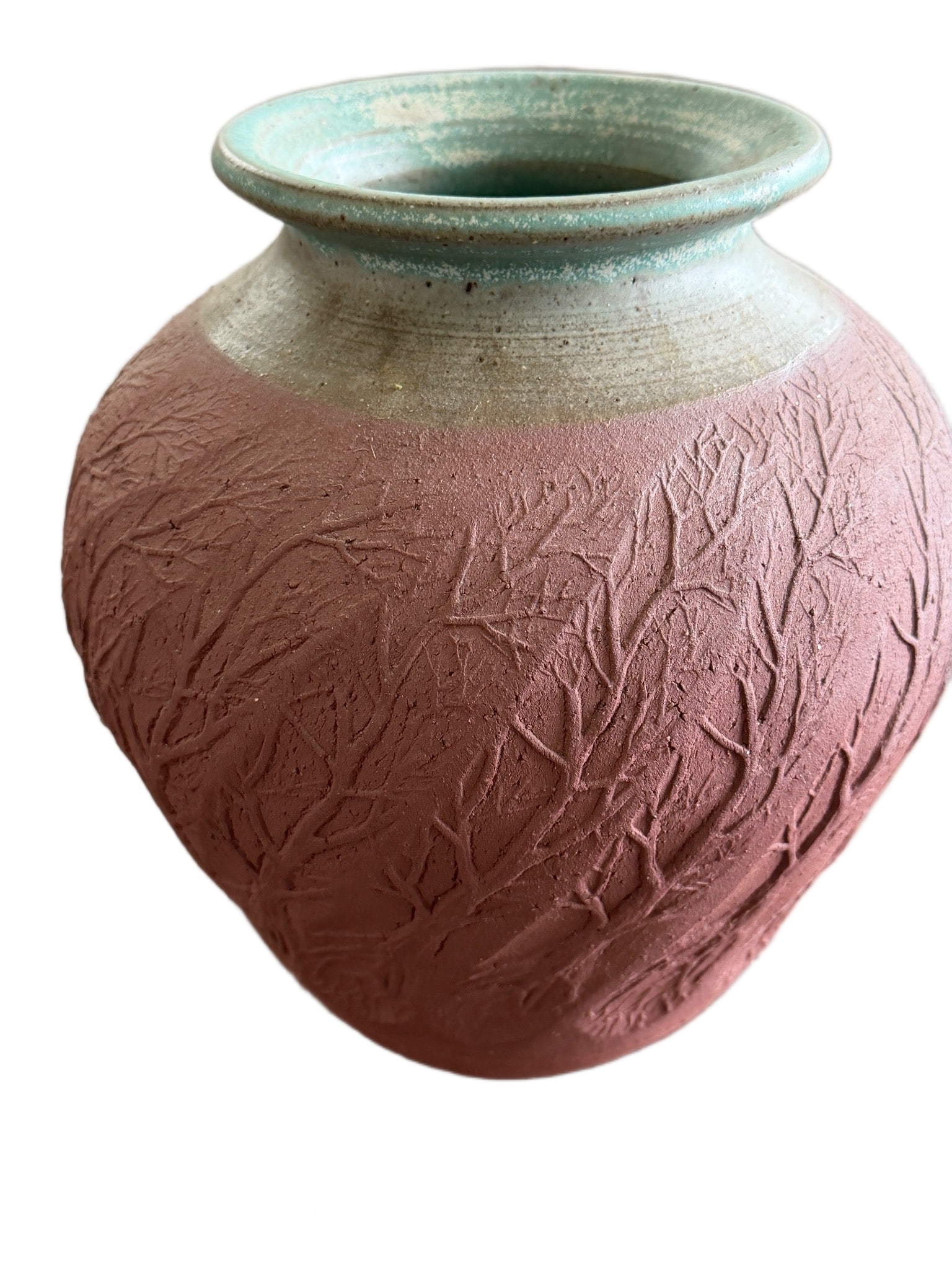 Stoneware Vase with Tree Motif by ‘From the Ground Up’: Stoneware vase with a textured tree motif on a red-brown background and a smooth green-glazed rim. The base is inscribed with 'From the Ground Up' and signed 'Mahan.' The vase measures approximately 7