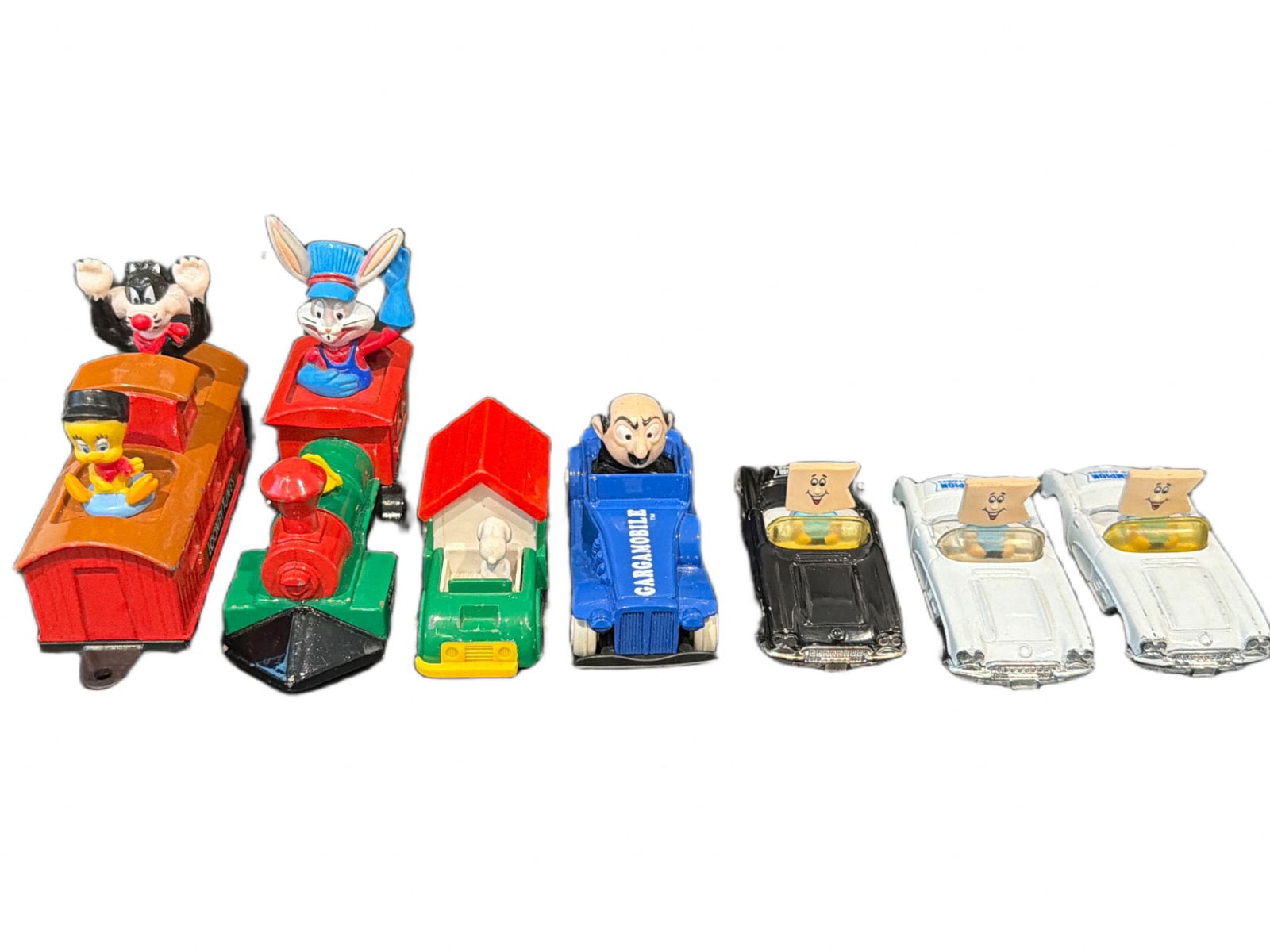 8 Assorted Character-Themed Toy Cars: 8 character-themed toy cars, featuring designs inspired by various characters and themes, including a red train with figures and cartoon-inspired vehicles. Made from a combination of plastic and die-c