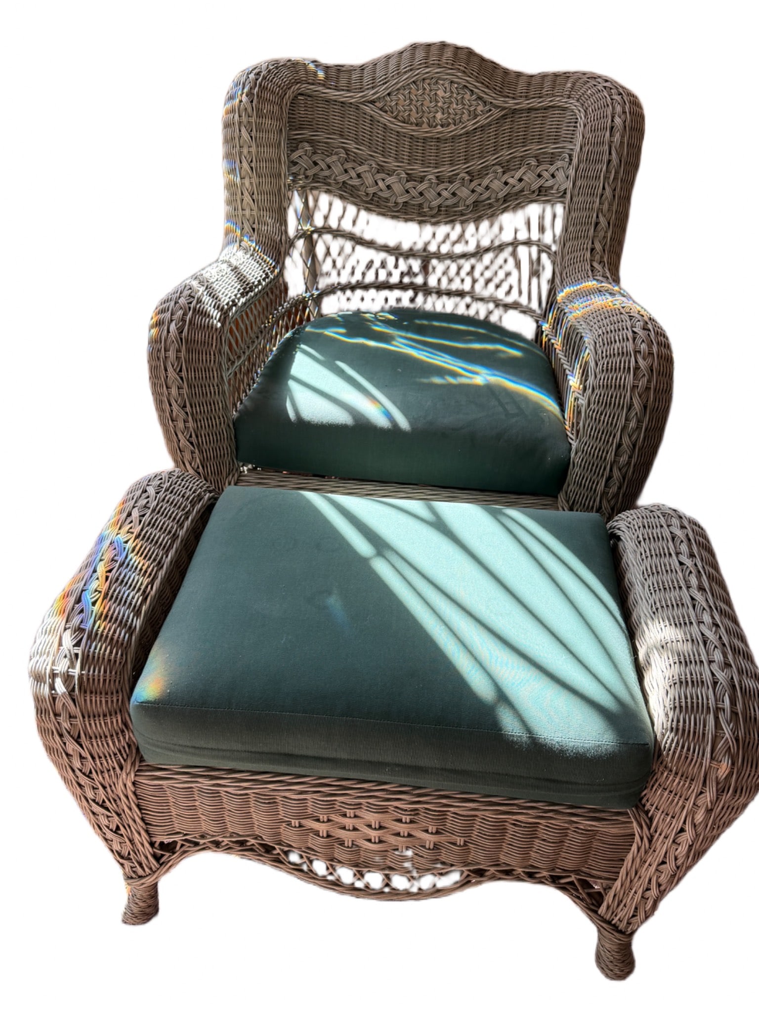 Wicker Armchair and Ottoman with Green Cushions: Wicker armchair and matching ottoman featuring intricate weaving and green cushions. The armchair measures 34 inches in height and 31 inches in width. Designed for comfortable seating, the pieces exhi