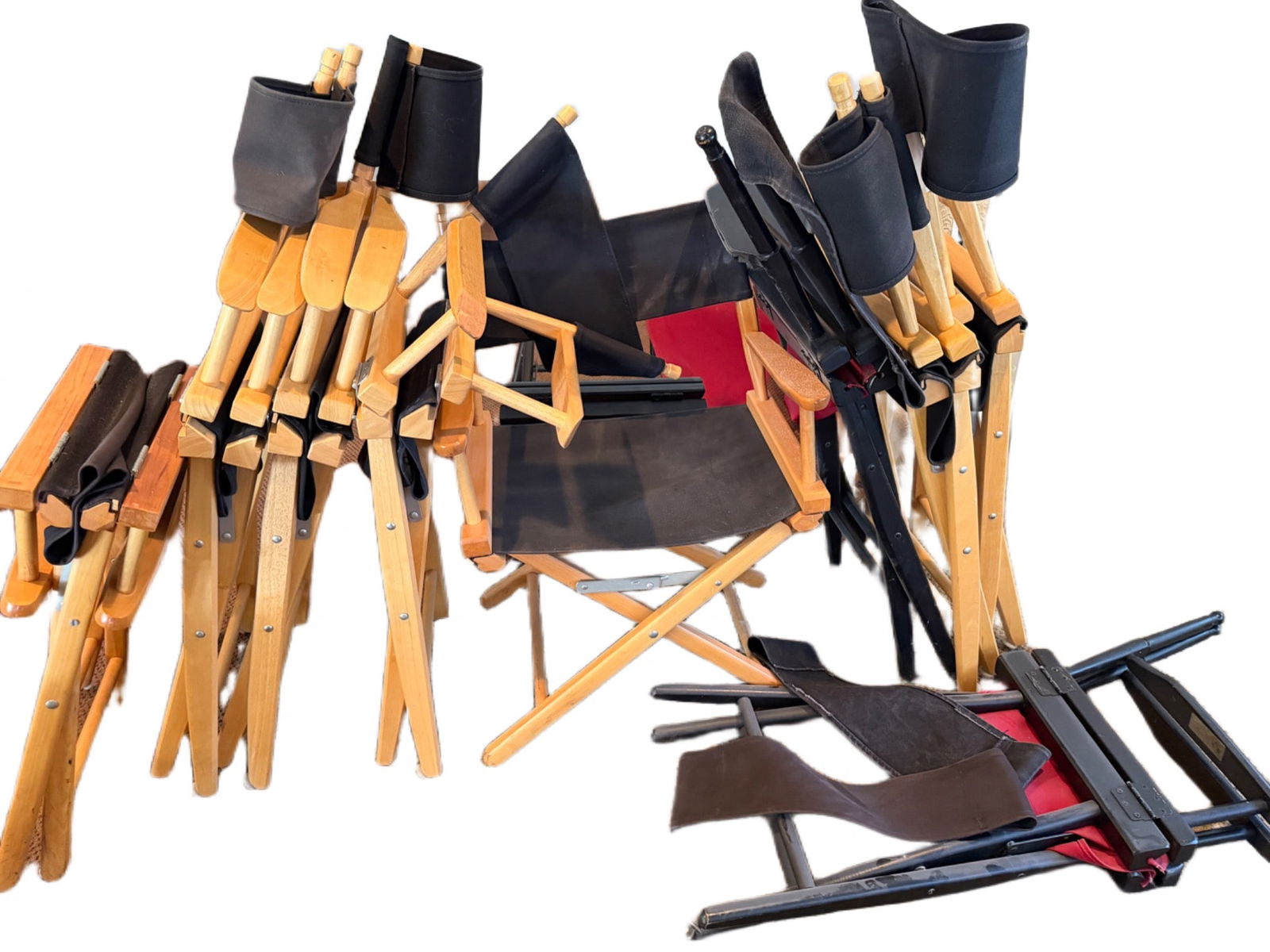Folding Director’s Chairs with Wooden and Metal Frames: Folding director's chairs featuring both wooden and metal frames, accompanied by black and red fabric seats and backrests. The lot displays a mix of completed and partially assembled chairs. Suitable
