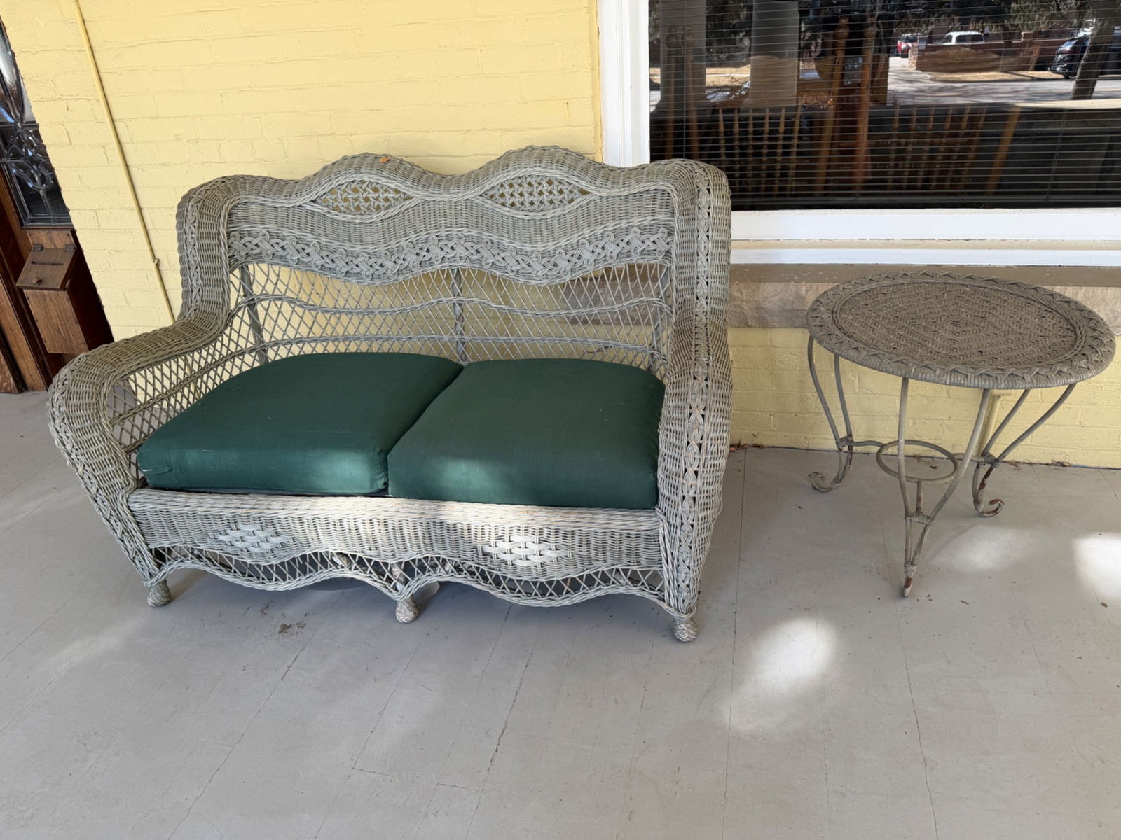Wicker Loveseat With Green Cushions and Matching Wicker Side Table (1 of 3)