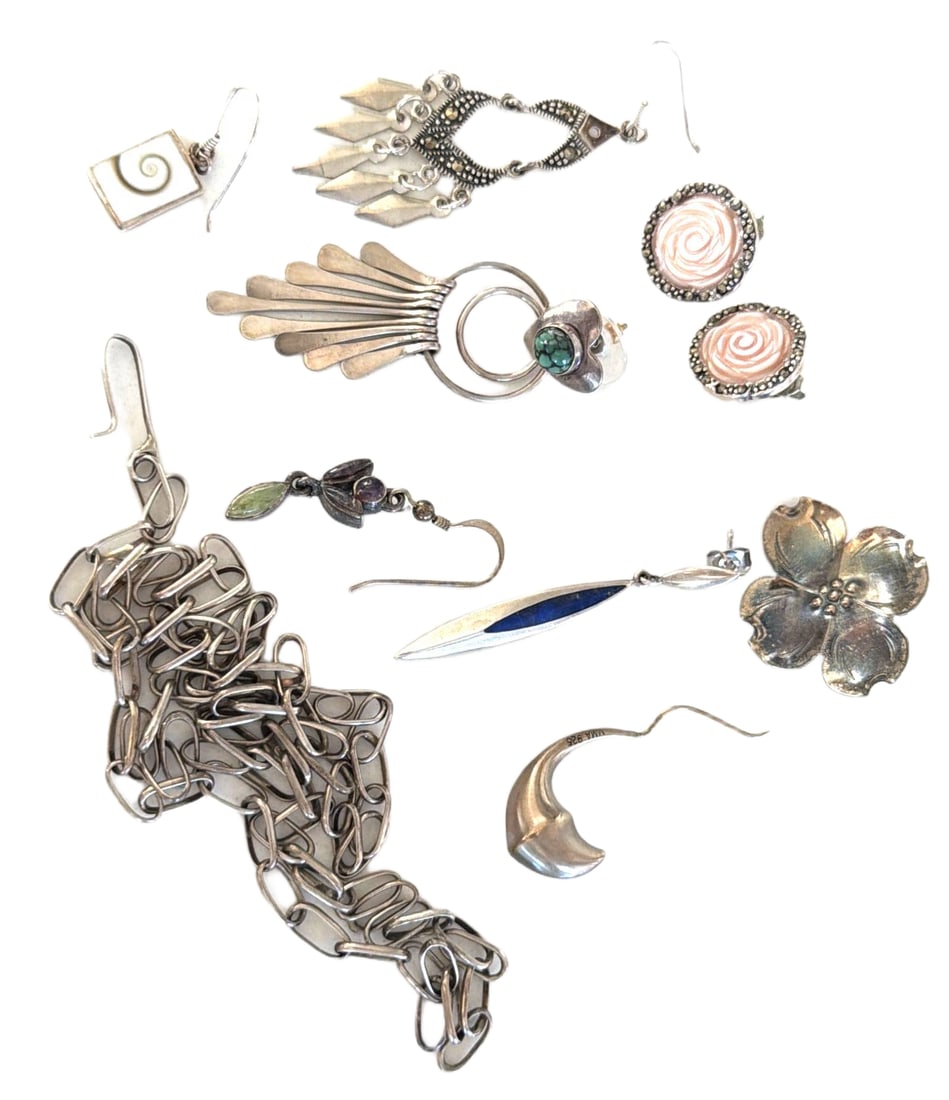 Sterling Silver Jewelry Featuring Earrings and Chain, Marked ‘Sterling’: Sterling silver jewelry, including earrings and a chain, marked with ‘Sterling’ and additional hallmarks. Designs feature floral motifs, abstract shapes, and inlaid details. Total weight is stated