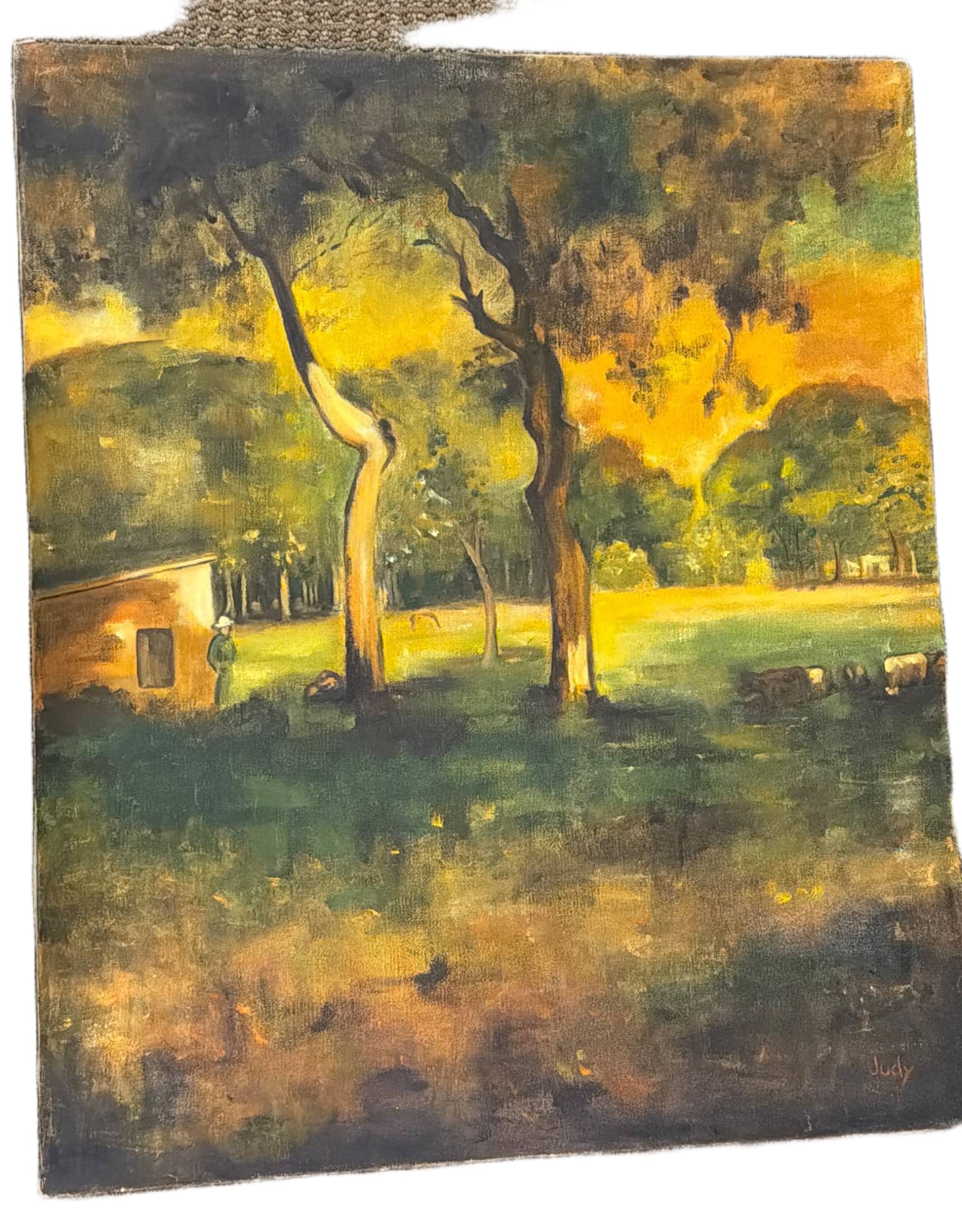 Framed Oil Painting of Landscape Scene with Trees and Pasture: An oil painting on canvas depicting a serene landscape with trees, a small structure, and grazing sheep, likely pastoral in theme. The artist’s signature, ‘Judy’ is visible in the lower-right co