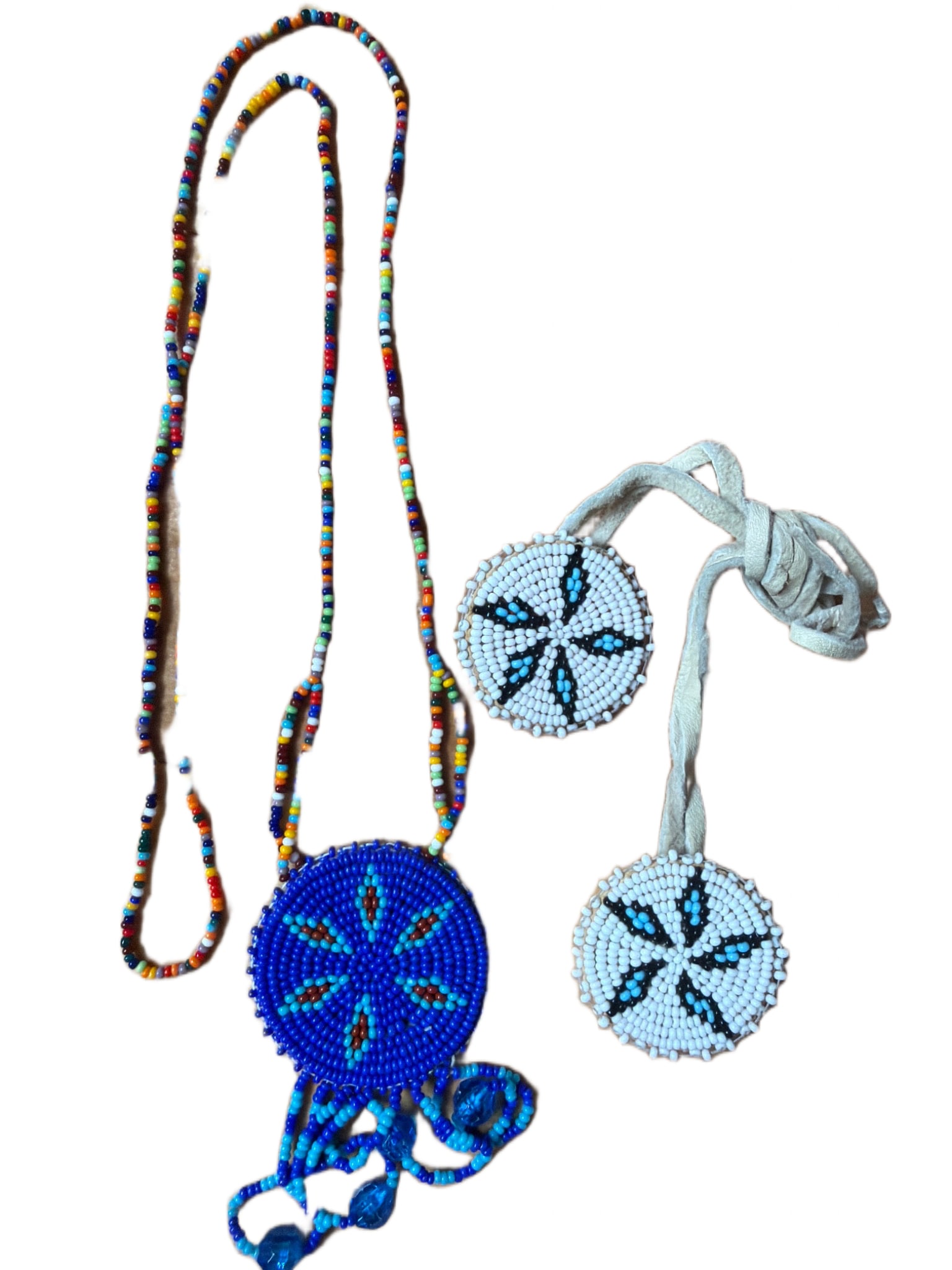 Handcrafted Native-American Style Beaded Medallion Necklace and Two Sets of Beaded Medallion: This final set includes a primary necklace featuring a circular medallion with a six-pointed star or flower motif in light blue and copper/brown beads, set against a deep cobalt blue background. It in