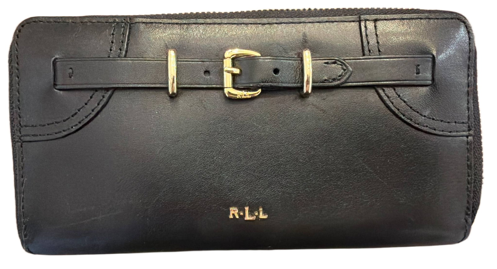 Ralph Lauren Black Leather Zip-Around Wallet with Gold-Tone Buckle Detail: Black leather zip-around wallet featuring gold-tone hardware and a buckle strap detail on the front. Branded 'RLL' logo displayed on the front. Interior includes multiple card slots, a zippered coin p