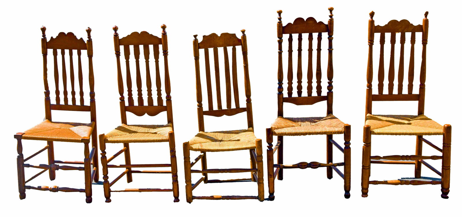 Set of Bannister Back Side Chairs: Assembled set of five 18th Century New England Bannister back side chairs with rush seats on stretcher base all in maple of various sizes.