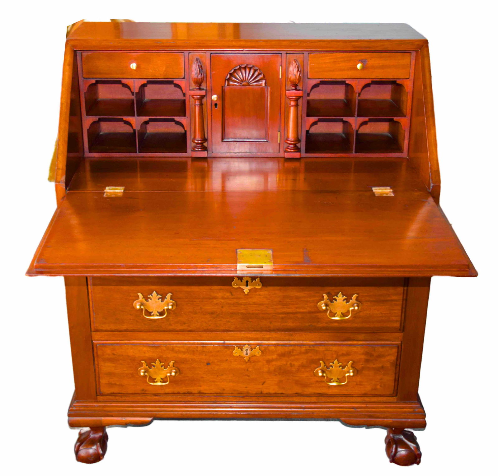 Slant Lid Desk: Colonial revival Chippendale style slant lid desk with fan carved lid, fitted interior including fan carving, 3 graduated drawers on claw and ball feet. Dimensions: 38" Height x 31" Width x 18" Depth