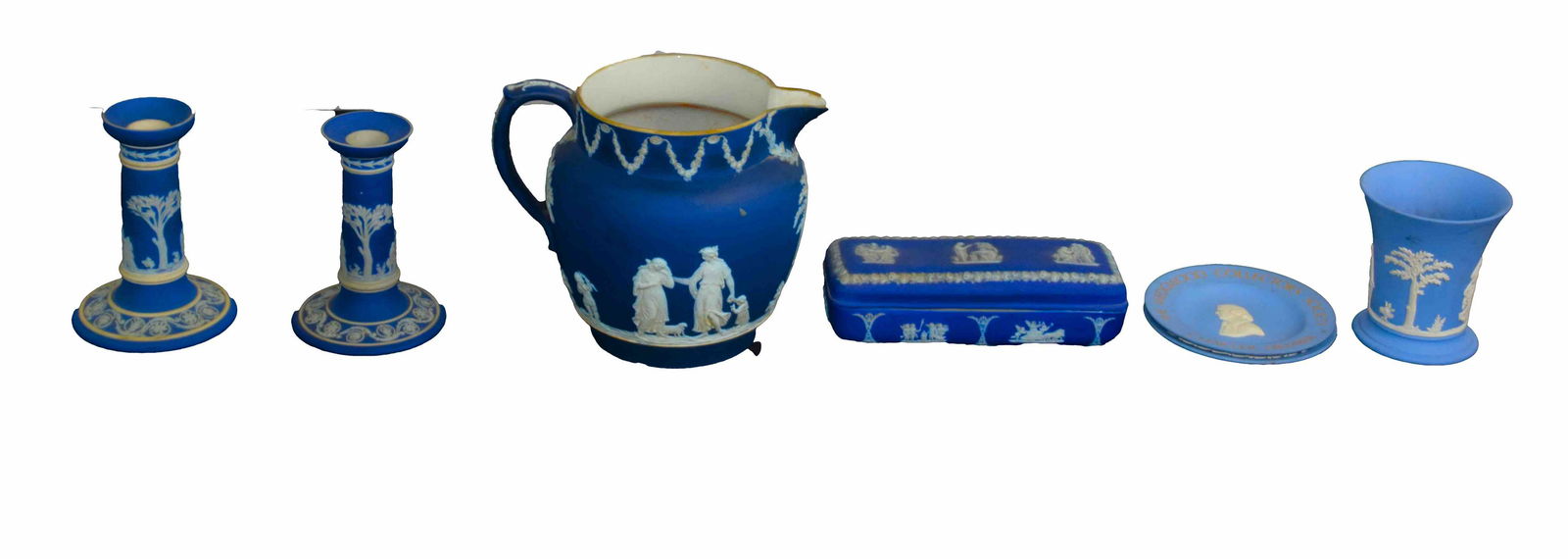 Wedgewood Lot: 6 piece blue and white Wedgewood, Jasper lot to include pitcher with handle 6.5" Height, pair of candlesticks on circular bases 5"Height, small vase 4" Height, 2 collectors plates 4.5" Diameter. Recta