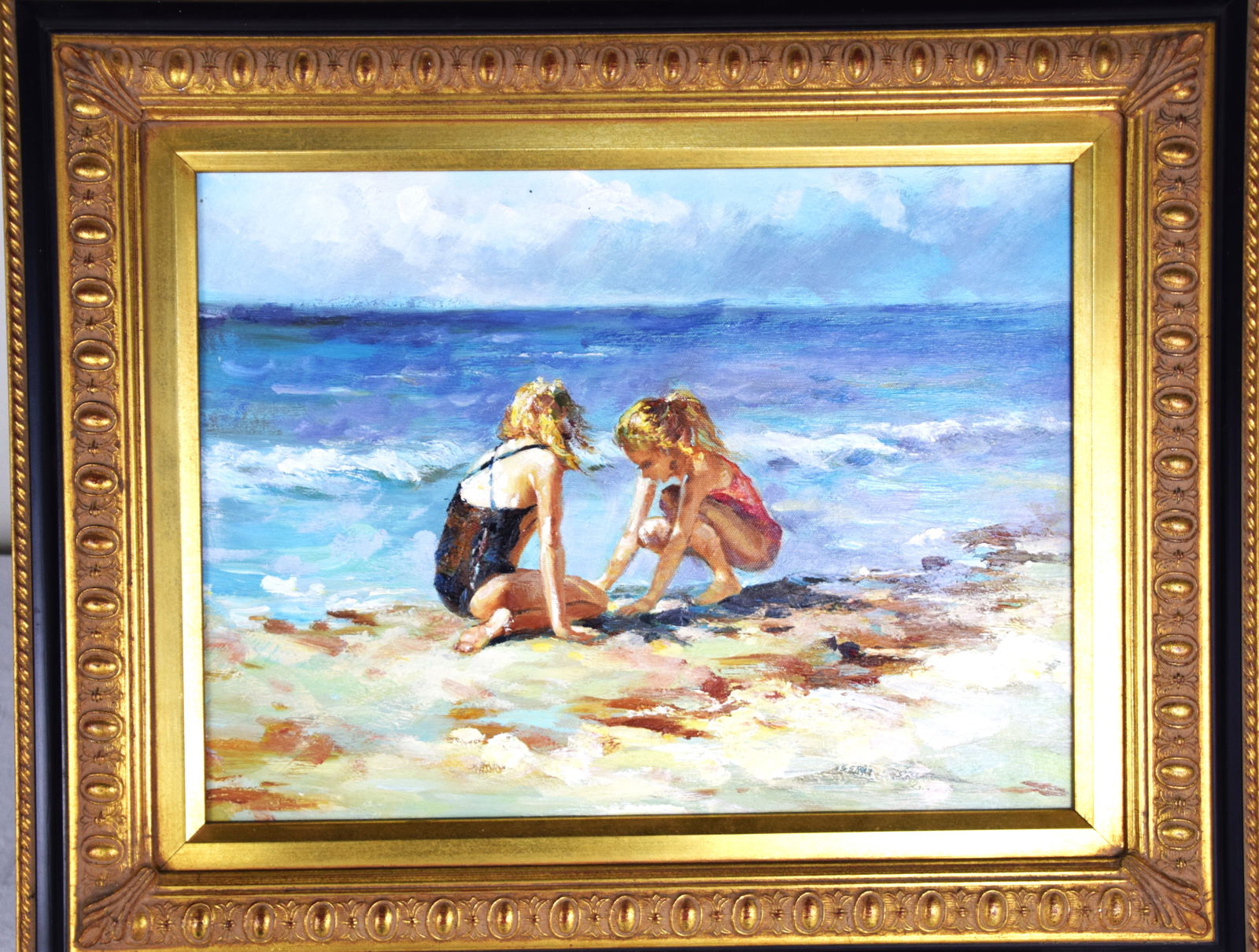 Beach Scene Oil: 20th Century oil on canvas of a beach scene with two girls on beach sand, framed. May be an artist initials in lower right corner. Painted in the manner of Edward Henry Potthast. Dimensions: 11.5" x 1