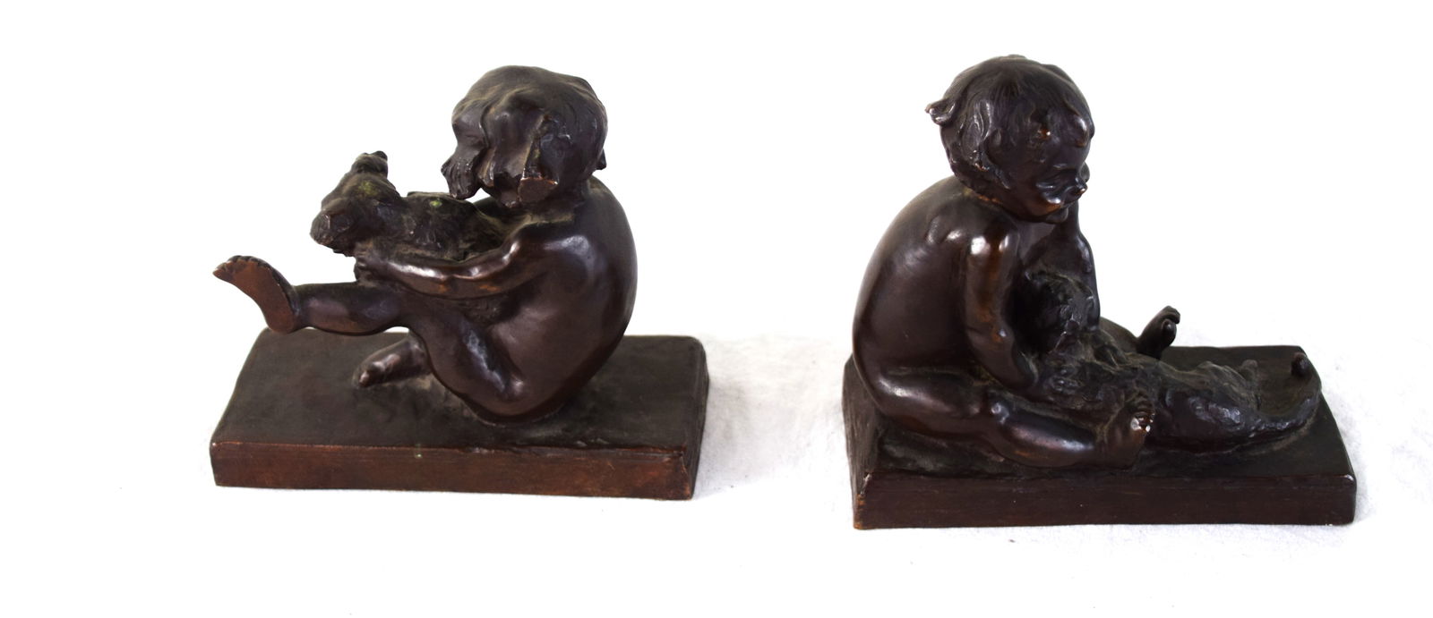 E. B. Parsons Bookends: E. Barreto Parsons bronze bookends with children, one holding a cat and another a dog. Made by the Gorham Foundry Company in 1914. Edith Barretto (Stevens) Parsons (1878 - 1956) worked in New York and