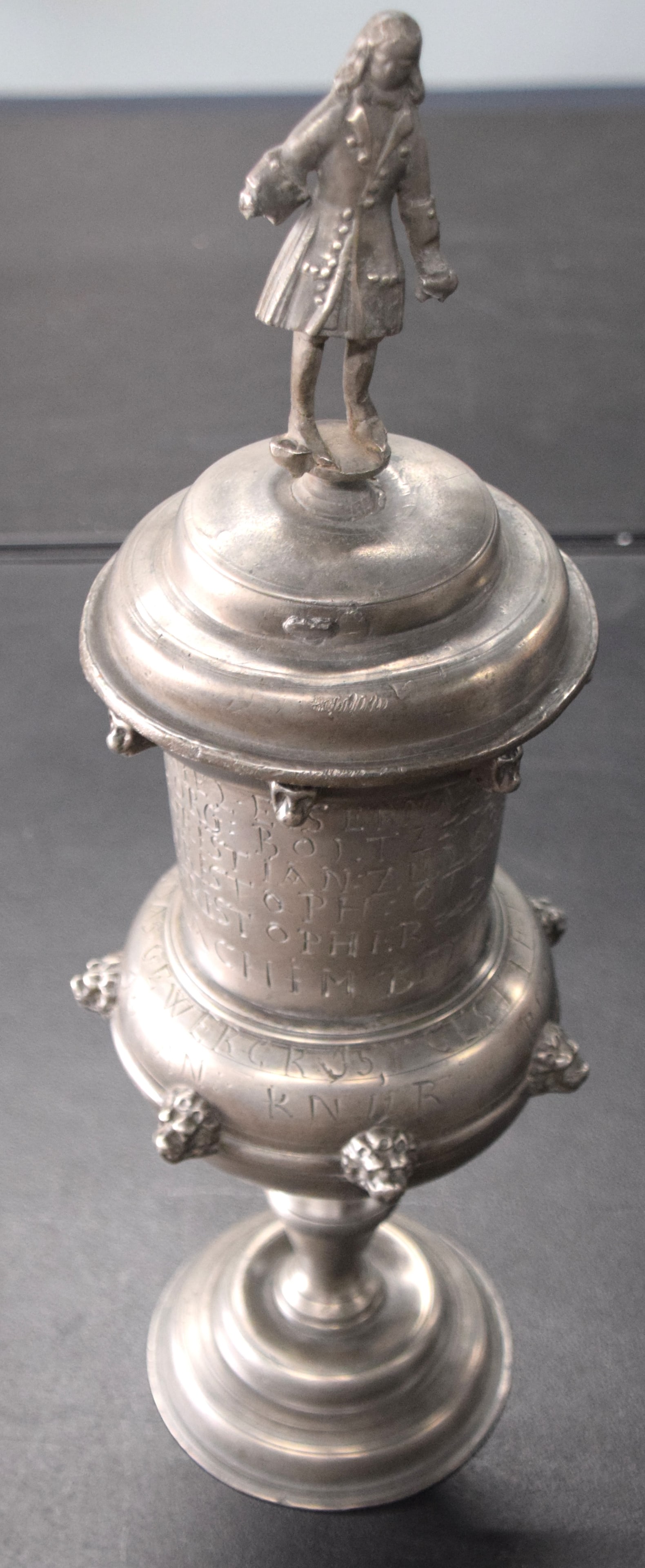 Pewter Gulden Guild Cup: Large pewter "Gulden" guild cup, German made by a Nuremburg pewterer with a noble figure on top and lettering on cup . Copy of an earlier cup with provenance included. Dimensions: 20.5" Height. From t