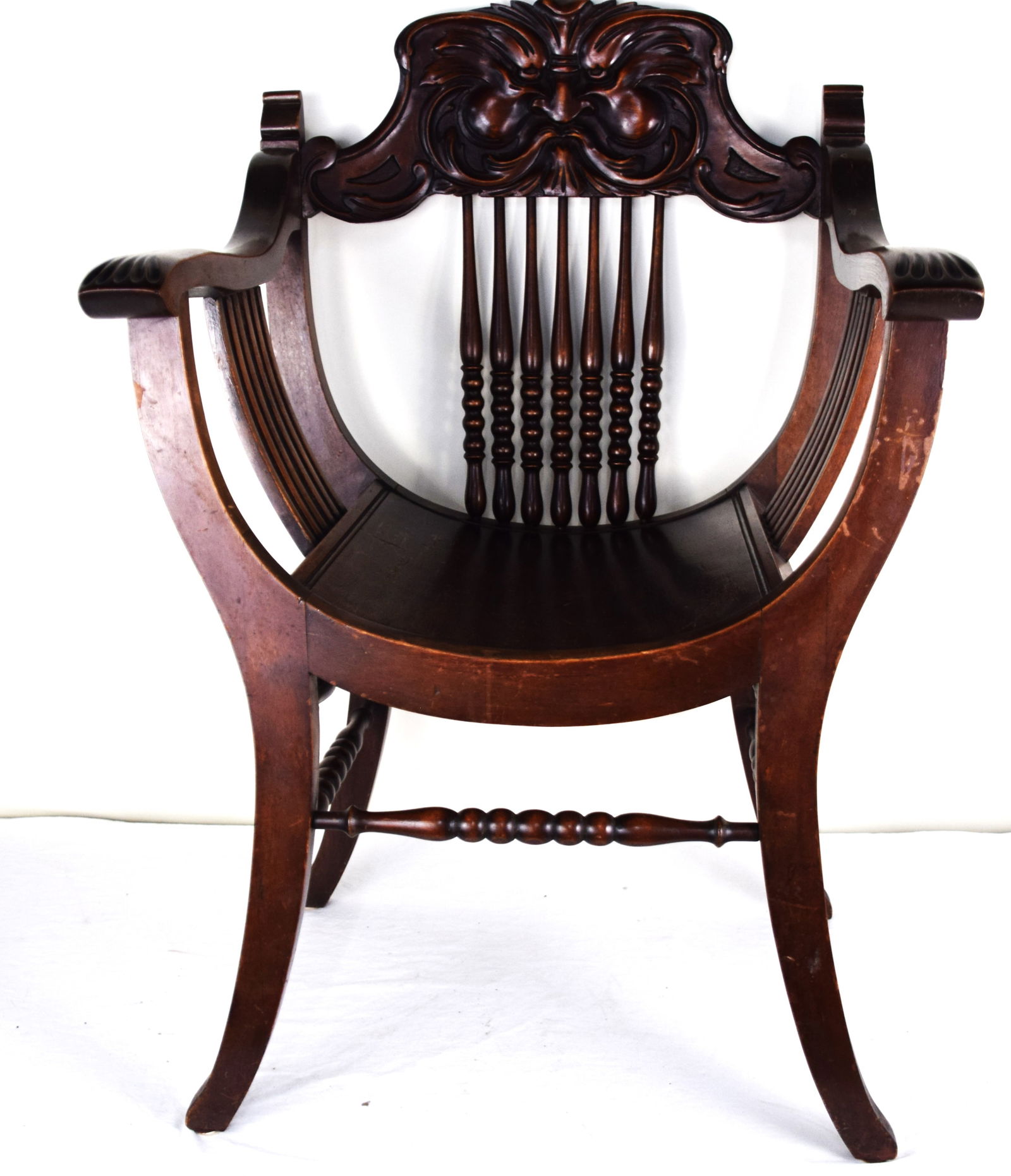 Carved Director's Chair: 20th century carved director's chair with spindle back and carved back splat of a North Wind Head. Dimensions: 17" Seat Height, 37" Height