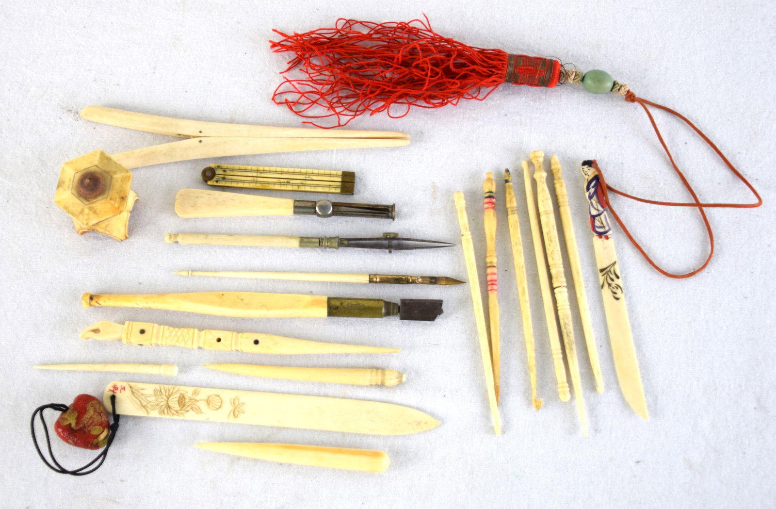 Large Whale Bone Lot: 19 Piece whale bone lot to include small slide rule, 4 tools, 1 tweezer, 2 letter openers, 1 small pagoda, and 10 needle points some carved. Dimensions: 4" to 7"