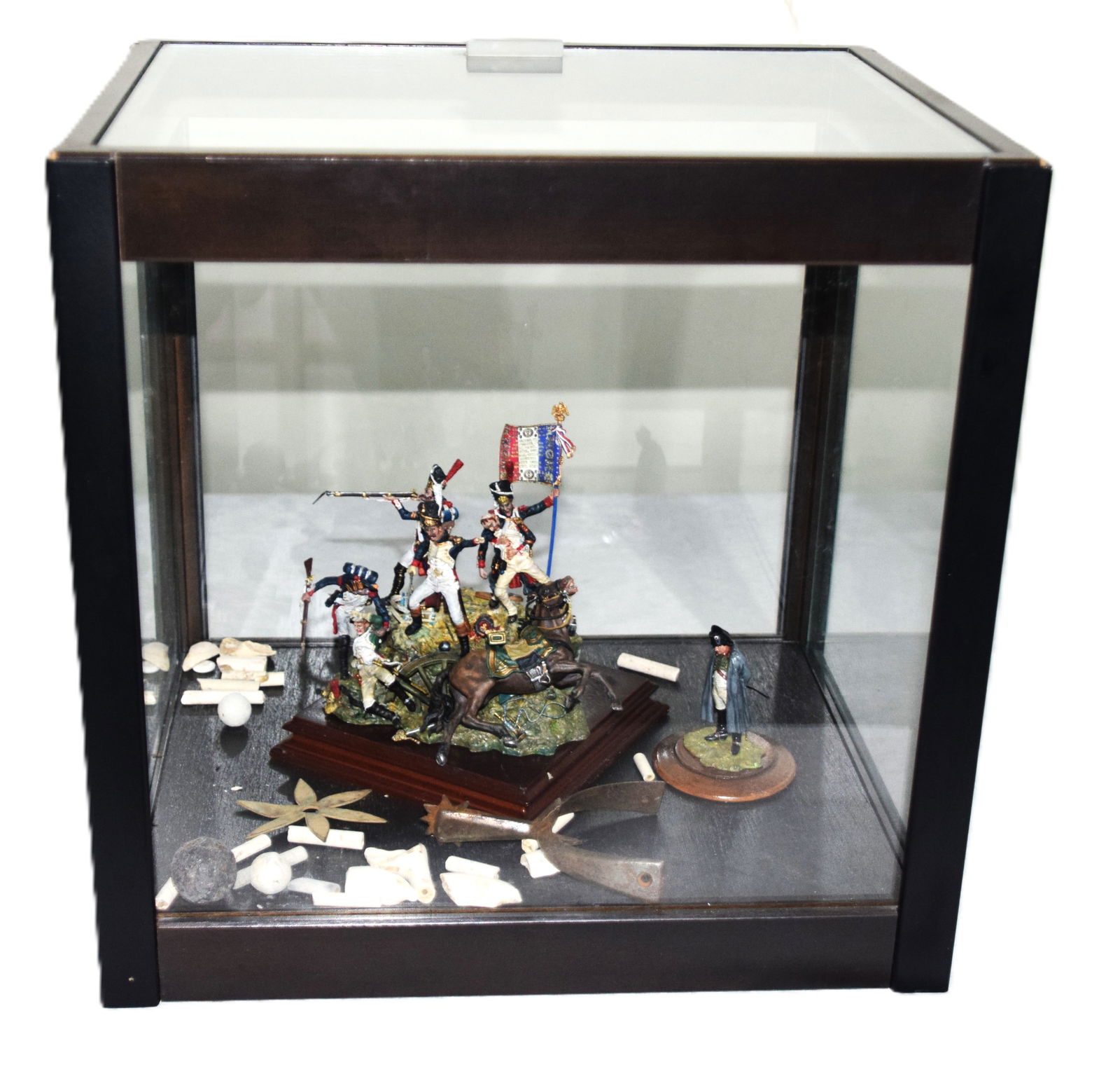 Battle Scene of Napoleon Soldiers With Relics: Battle scene of Napoleon soldiers along with a statue of Napoleon in a glass case titled Dernier Carre or Last Four. Also included are fragments from a battlefield to include French 24gr ball, British