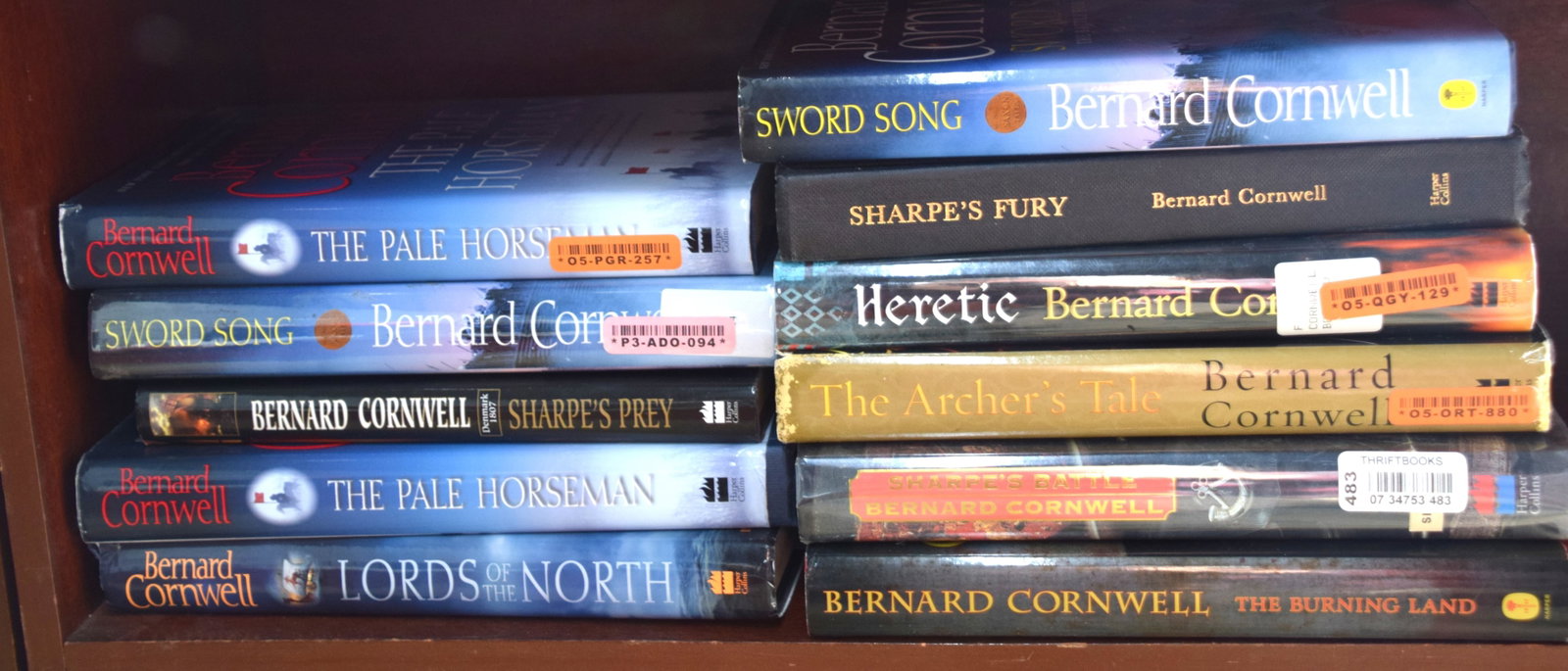Bernard Cornwell Lot: Eleven volumes of Bernard Cornwell books to include: The Heretic, Sword Song, Sharpe's Prey, Sharpe's Fury, The Archer's Tale, Lords of the North, The burning Land and more