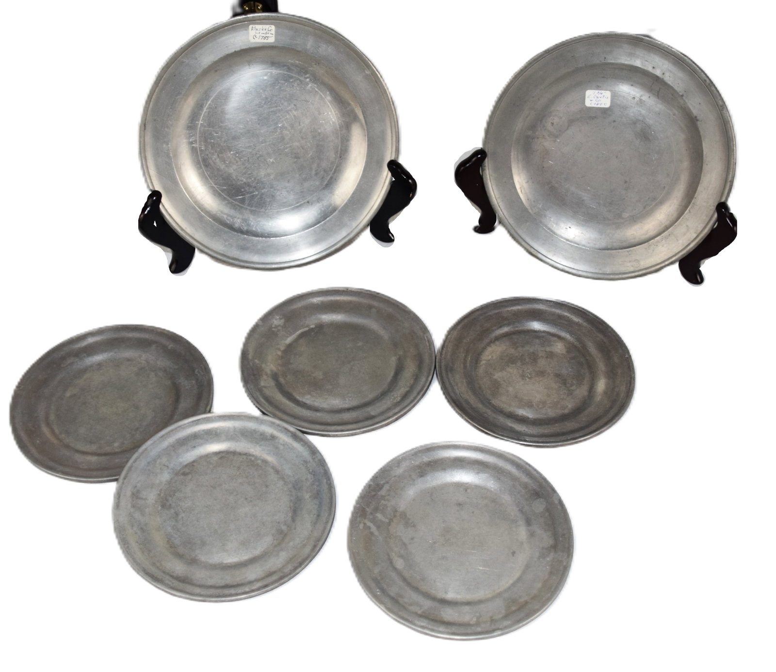 Pewter Lot: Seven piece pewter lot to include pewter plate, Bush & Co., 1785 (8" Dia) and E. Curtice 1800 (8" Dia) and five pewter plates (6" Dia)
