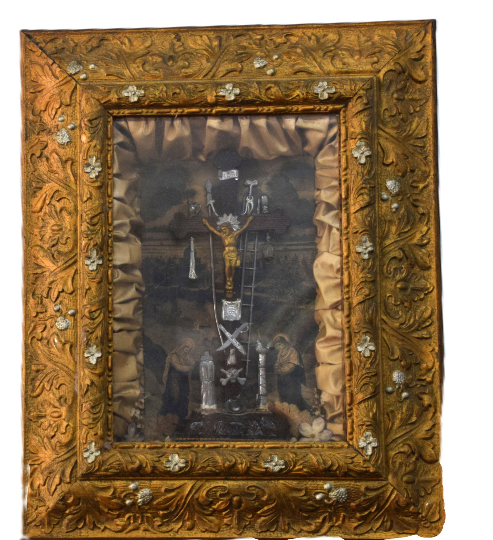 Shadow Box Of The Crucifixion: Crucifixion of Christ in an elegant shadow box with both Marys praying and silver items around the crucifix including a ladder. Dimensions: 21" x 17" x 4"