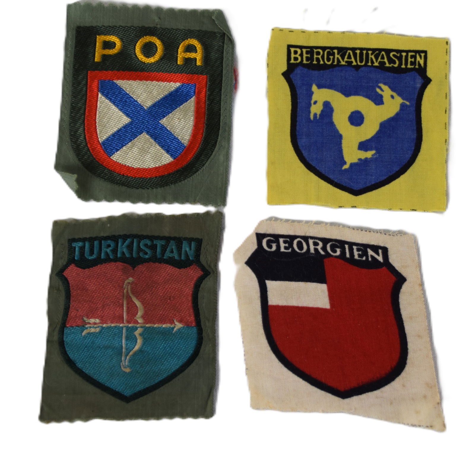 4 Rare WWII Sleeve Insignia: Four rare WWII sleeve insignia including a Russian Liberation Army (POA) screen printed insignia with the blue cross of St. Andrew, a Foreign Volunteers Berkaukasien insignia representing the