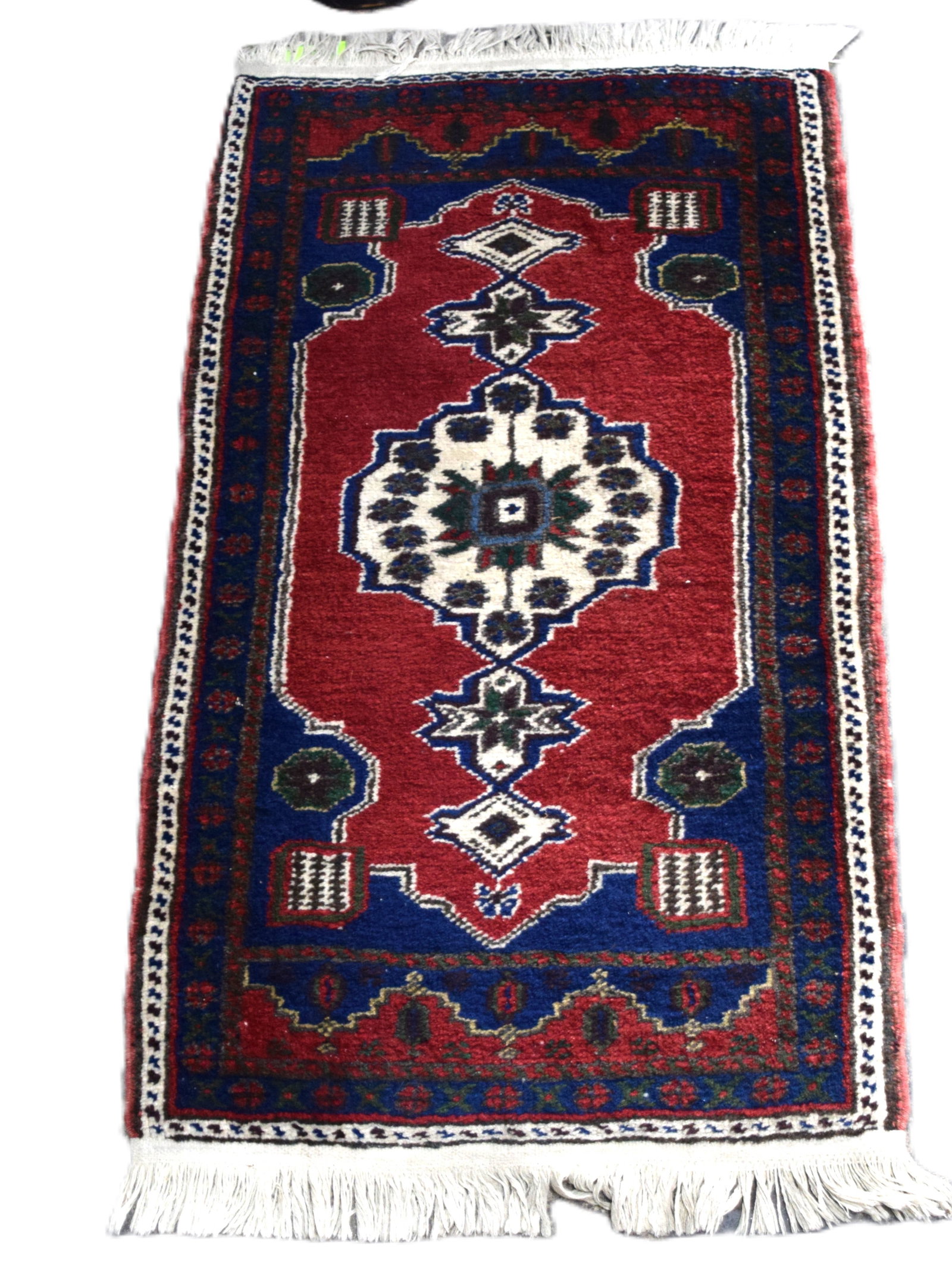 Oriental Scatter/Prayer Rug: Oriental scatter/prayer rug, multi-color with reds, blues and ivory with multi-designs. From a New London NH home. Dimensions: 1'11" x 3' 5"