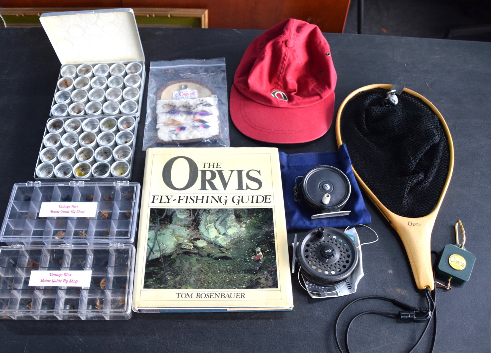 Orvis Fishing Lot With Orvis Coat: Orvis fishing lot to include coat, vest and hat, a net, reels, book and several fishing flies.