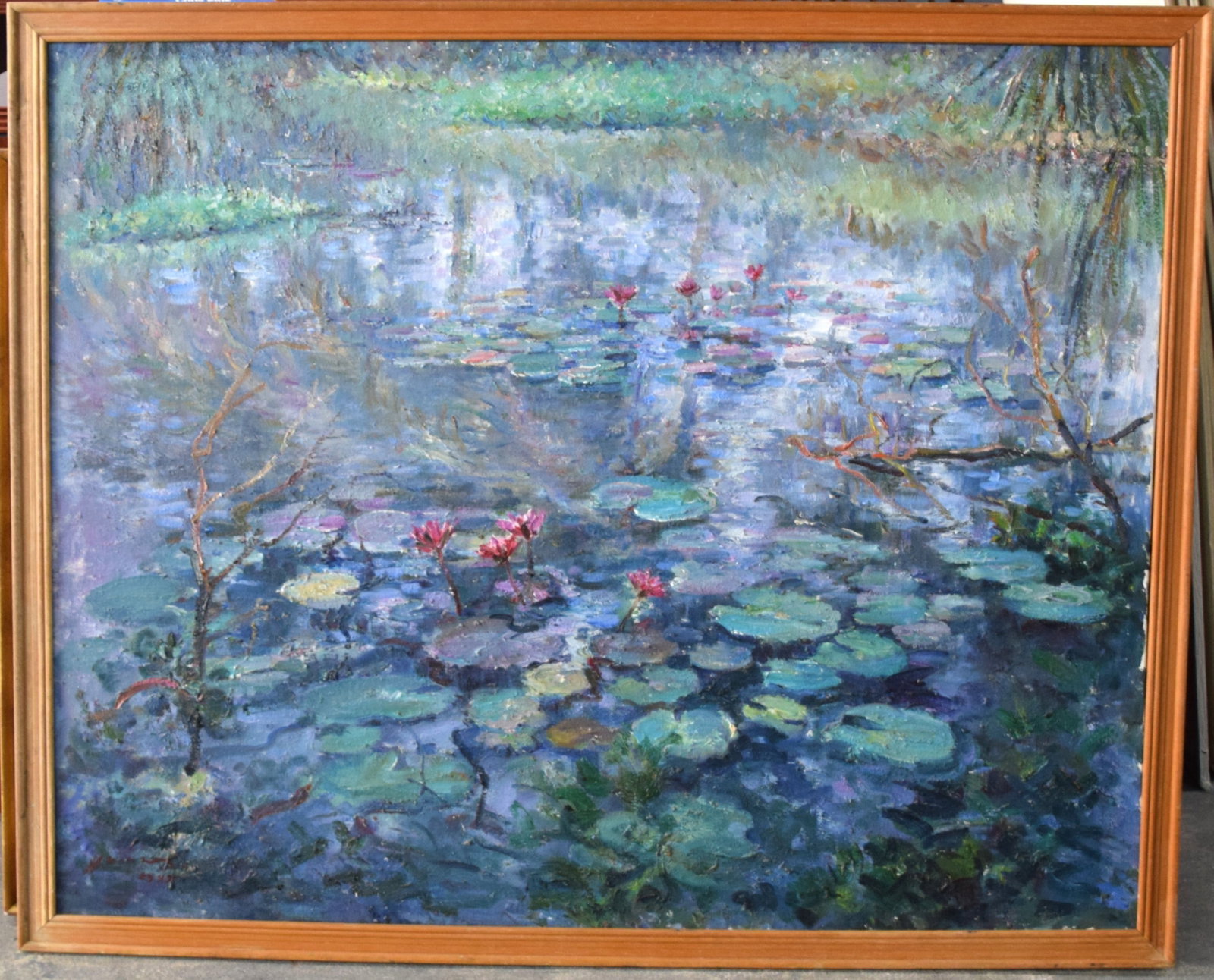Monet Style Water Lillies Oil painting: Framed oil on canvas of flowering water lilies in a pond after the French impressionist painter, Monet. Signed lower left illegible. Dimensions: 32" x 39" Image size