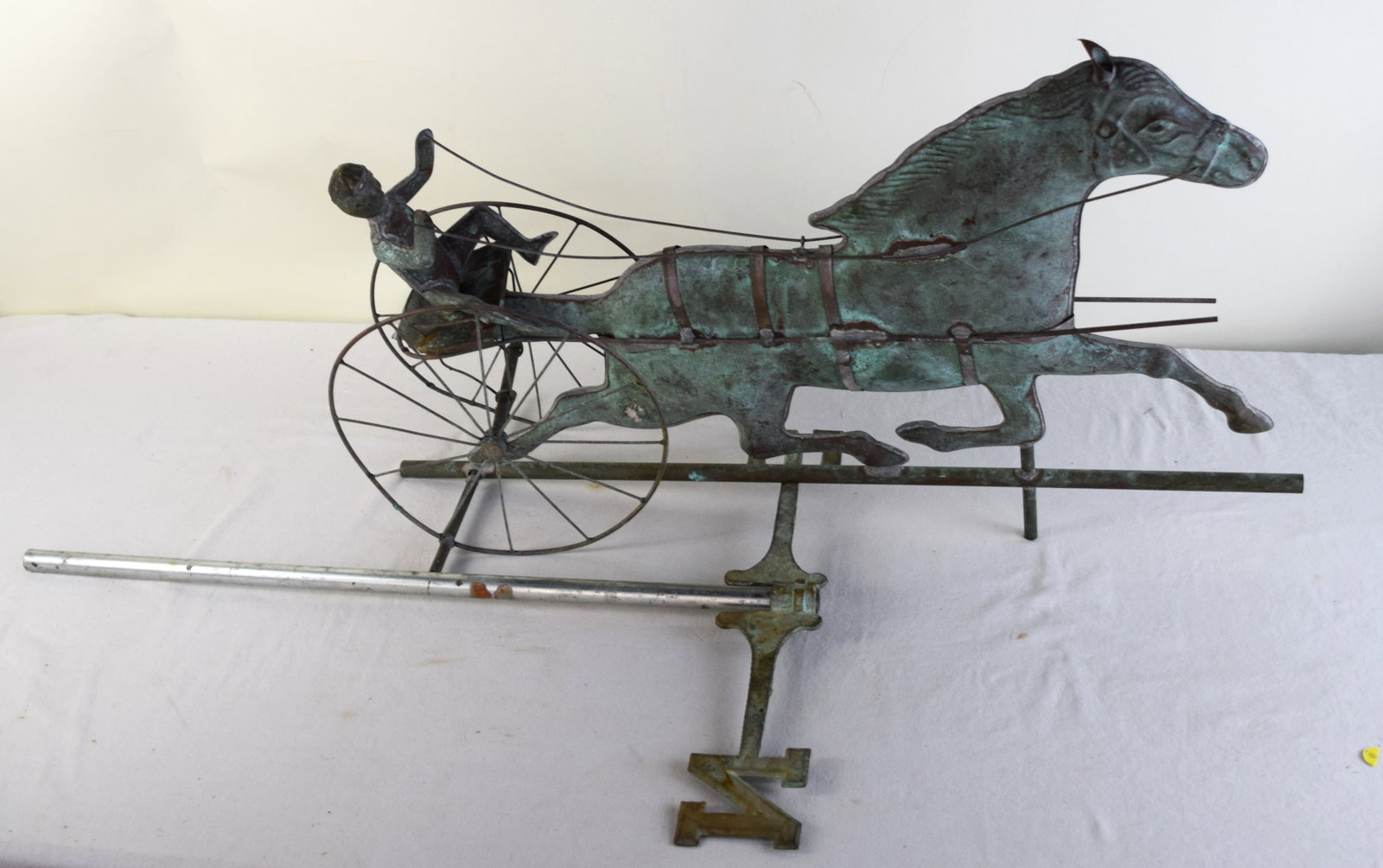 1960s Vintage Sulky Weathervane: Running horse sulky weathervane in copper with the driver and sulky and with a N and S directional indicator. Dimensions: 31" L x 18" H