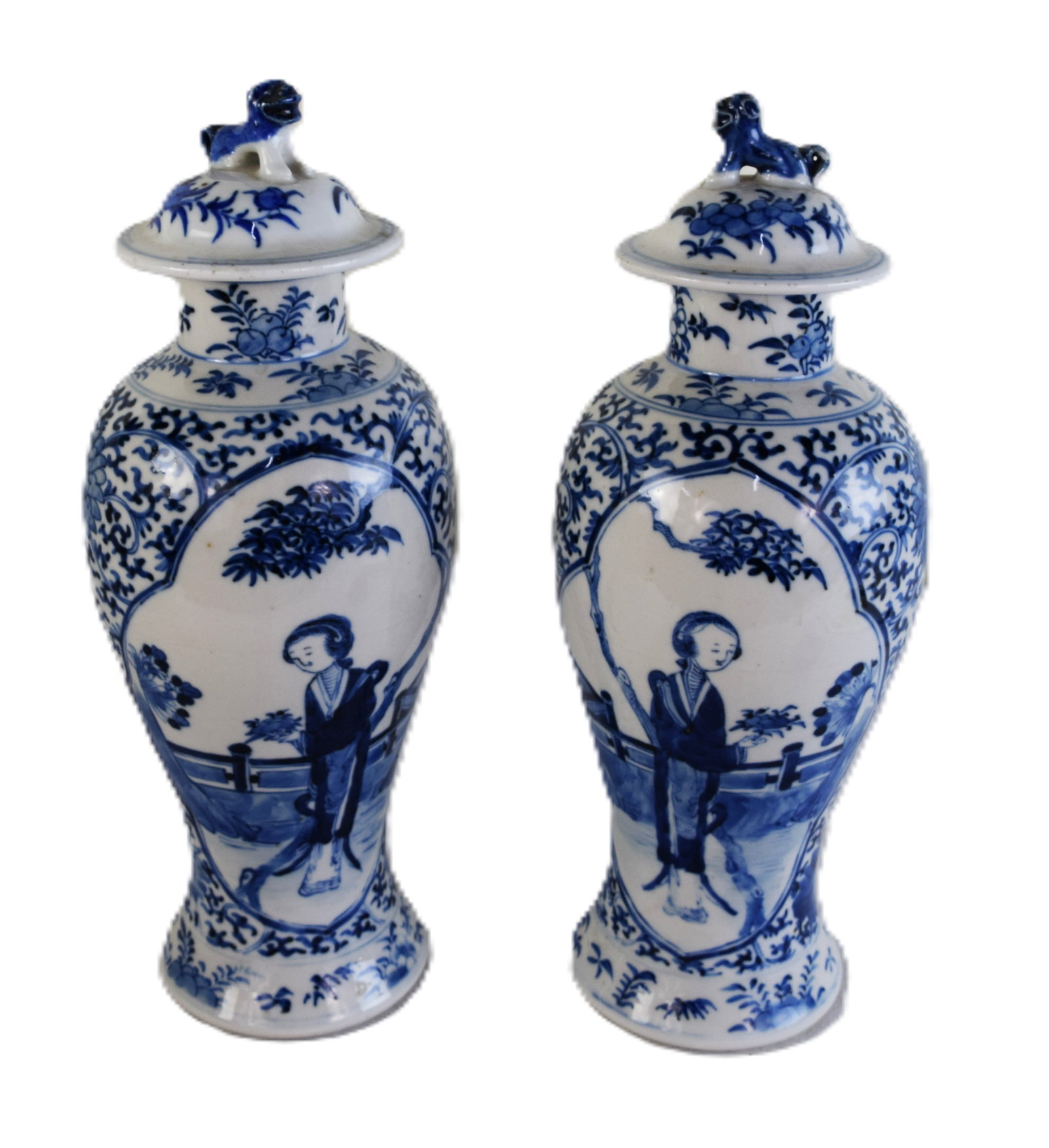Pair of Chinese Vases: A pair of Chinese vases and covers, late 19th century (Guangxu period 1875?1908)each shaped body fitted with a Foo Dog cover, decorated with courtesans by a garden fence with flowers and other