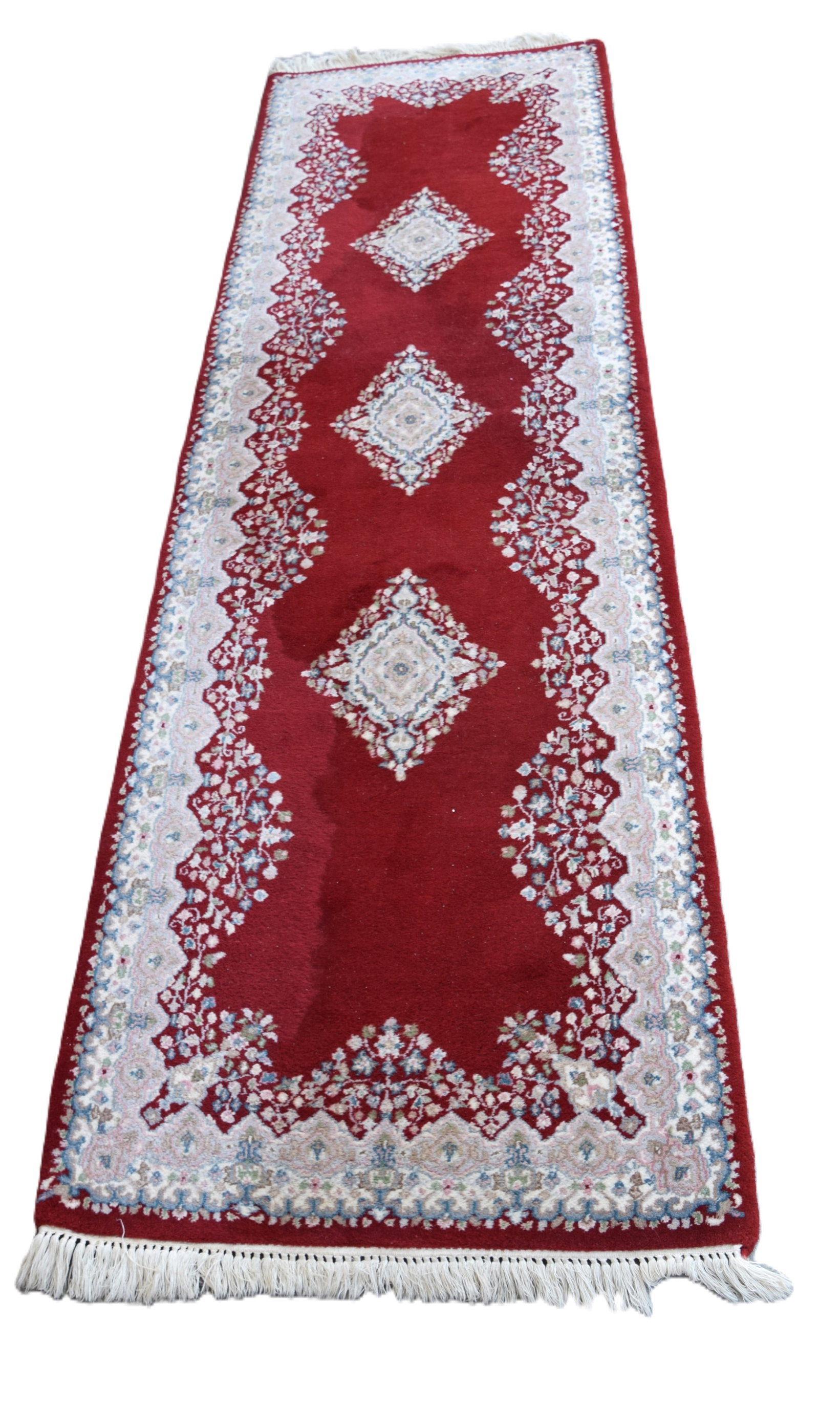 Kerman Oriental Runner: Kerman oriental runner with a predominant red field with designs both floral and medallions with a good thick pile. From a Salem NH home. Dimensions: 2'8" x 8'11"