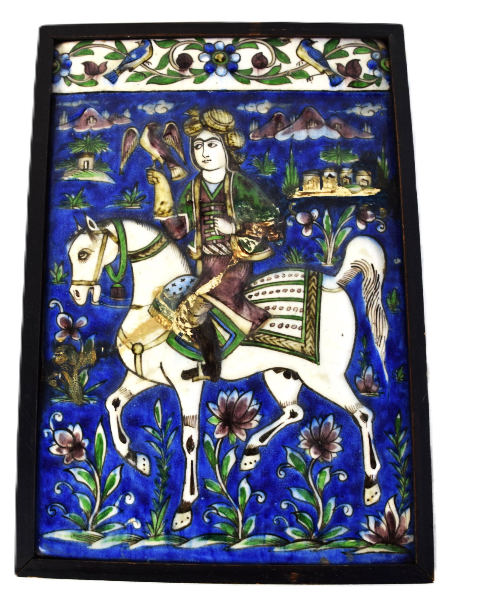 Persian (Iranian) Qajar Painted Ceramic Tile Of A Falconer: A Persian (Iranian) Qajar-style painted ceramic tile, whose subject is a falconer on horseback, a classic Persian motif that was popular during the Qajar period (1789?1925). Probably a late Qajar or