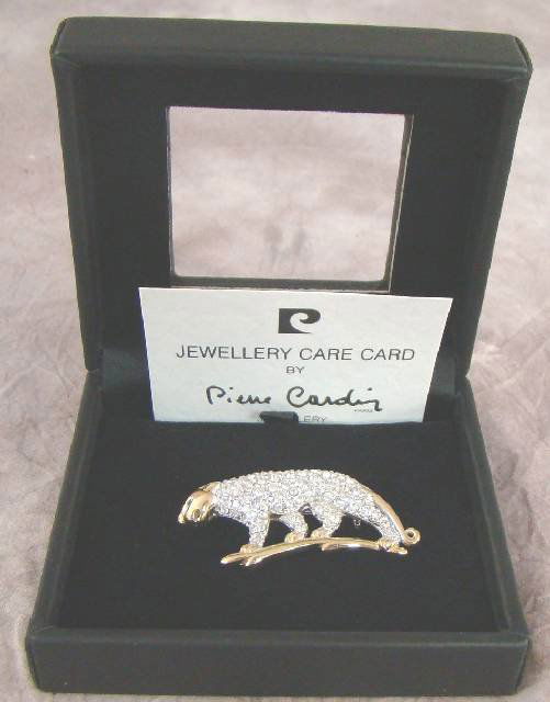 BOXED PIERRE CARDIN LEOPARD BROOCH: BOXED PIERRE CARDIN LEOPARD BROOCH , modelled as a Leopard walking on a branch, set with diamante all over the body, and a gold coloured branch, face and tail. 5cm x 2cm. The back is stamped with the